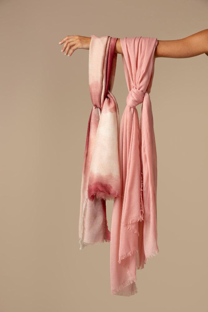 Colorful collection of cotton scarves neatly displayed, showcasing various patterns and styles. Ideal for accessorizing any outfit, these lightweight and breathable scarves provide both comfort and fashion.