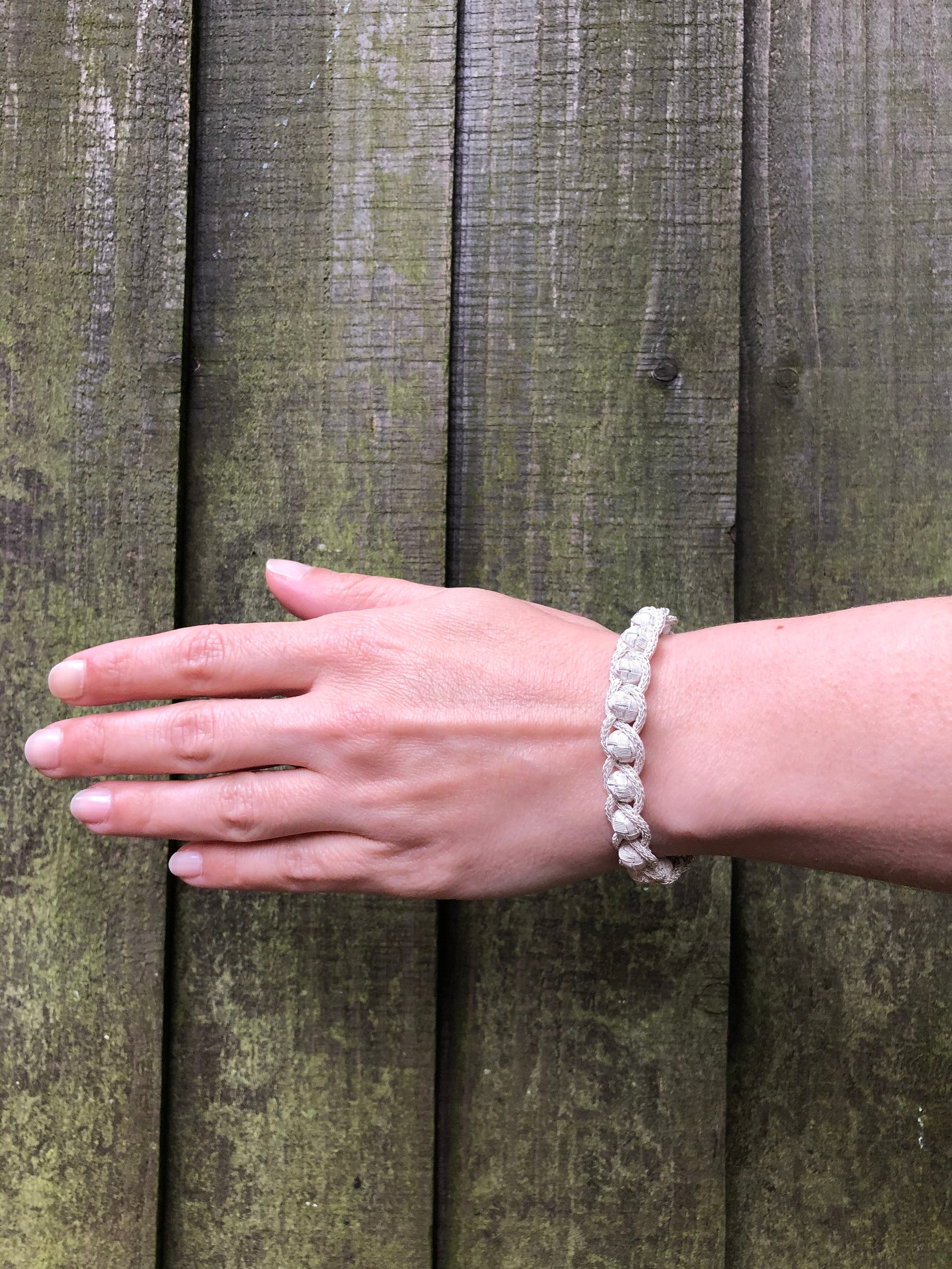 Add a touch of glamour to any outfit with this sterling charm braid knit wire jewelry bracelet. It's perfect for anniversary gifts, silver wedding presents, or just because.