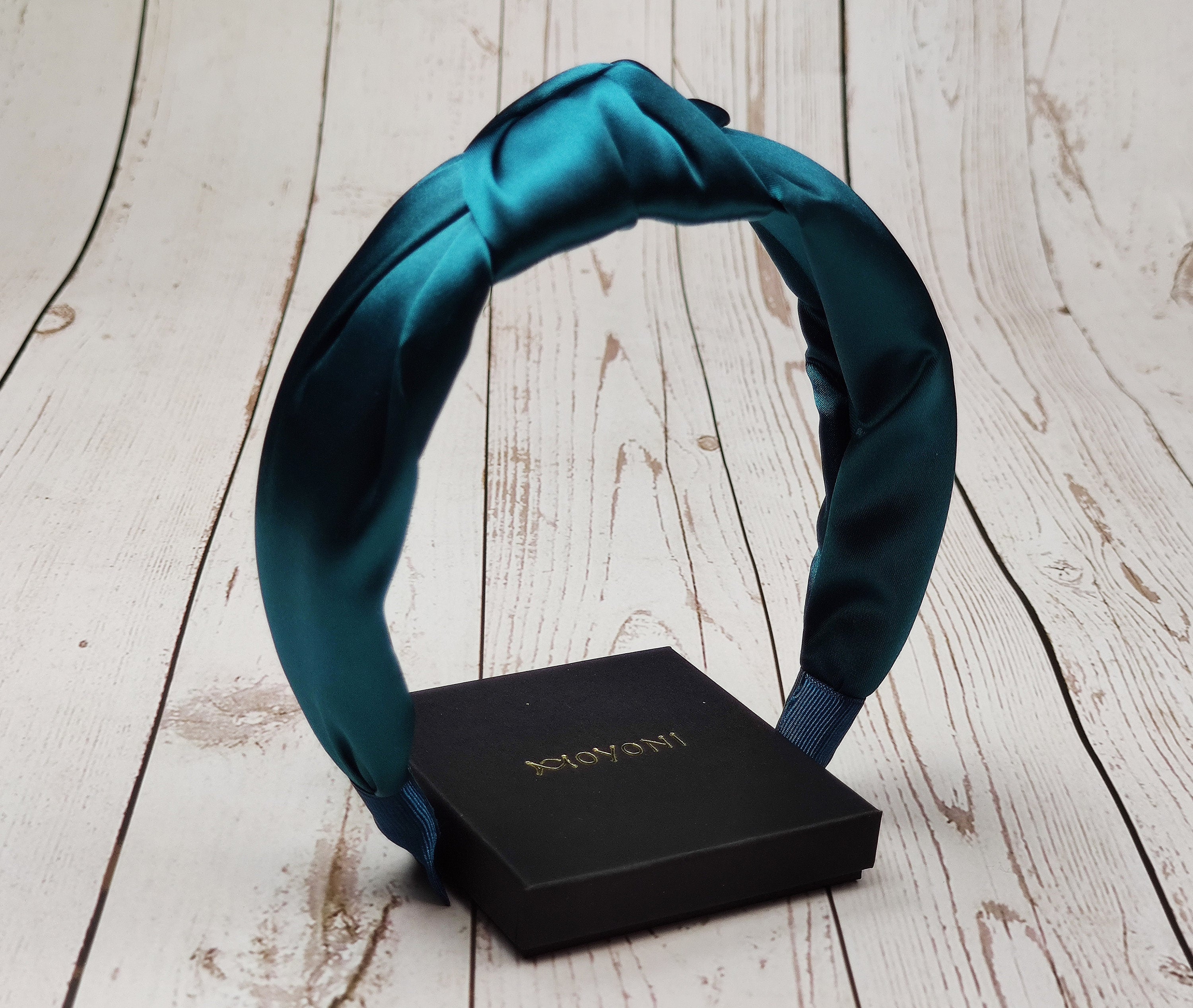 Add a touch of luxury to any outfit with this feminine and stylish knot headband. Made from light purple satin fabric, this headband is perfect for special occasions or days when you want to look your best.