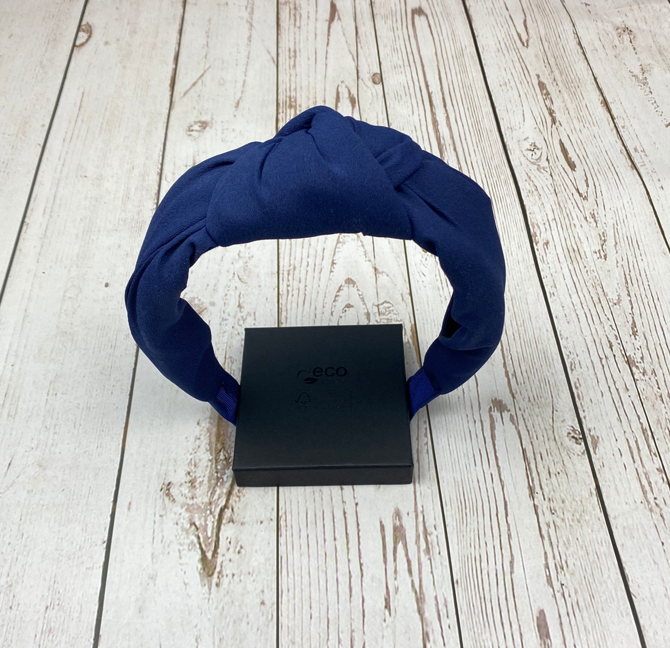 Make a statement with this dark blue fabric hairband, a stylish and versatile accessory for women.