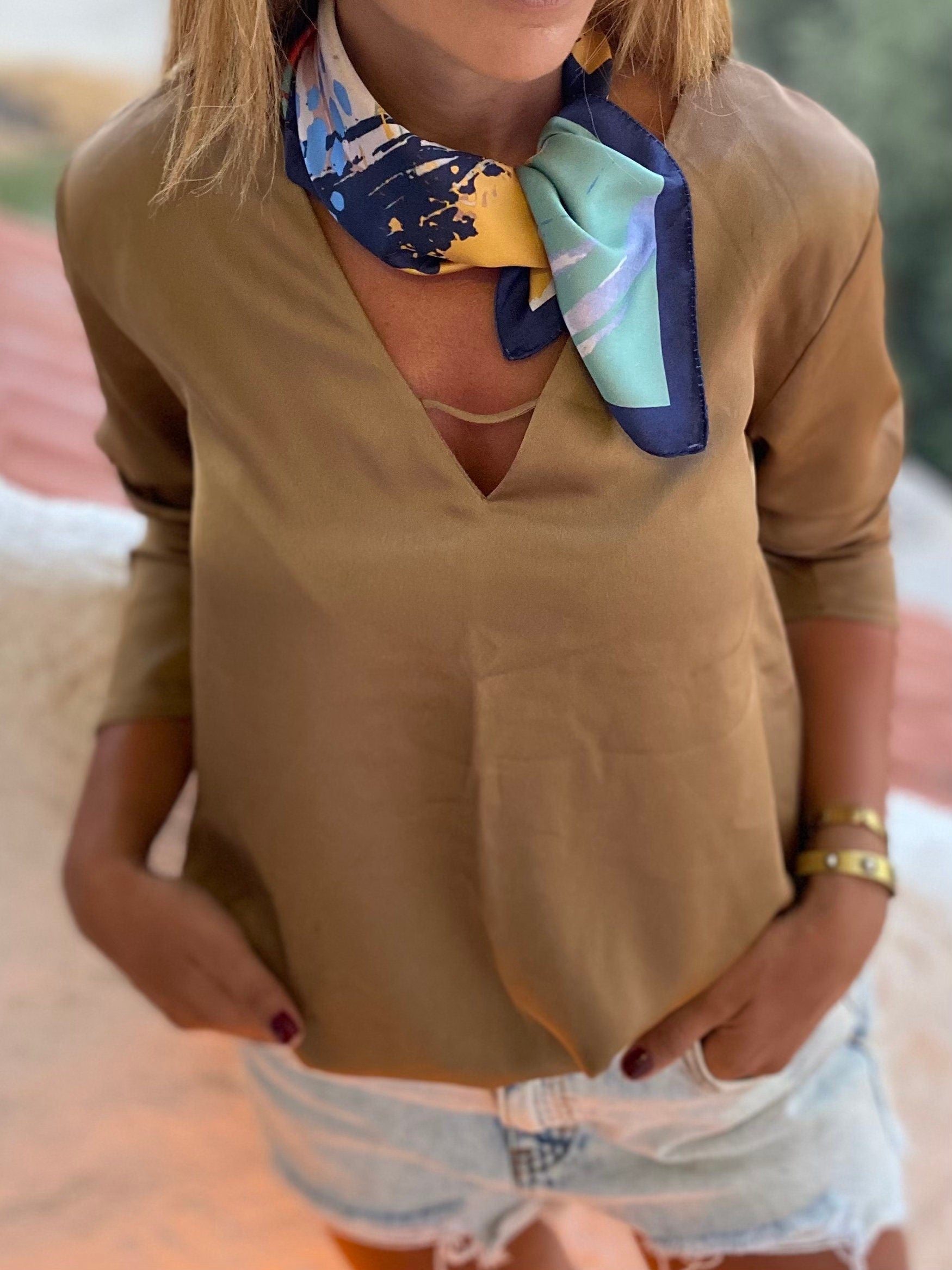 Get ready to make a statement with our Satin Scarf in Dark Blue and Yellow. Perfect for adding a pop of color to any outfit, this neck scarf is made from soft and comfortable satin material.
