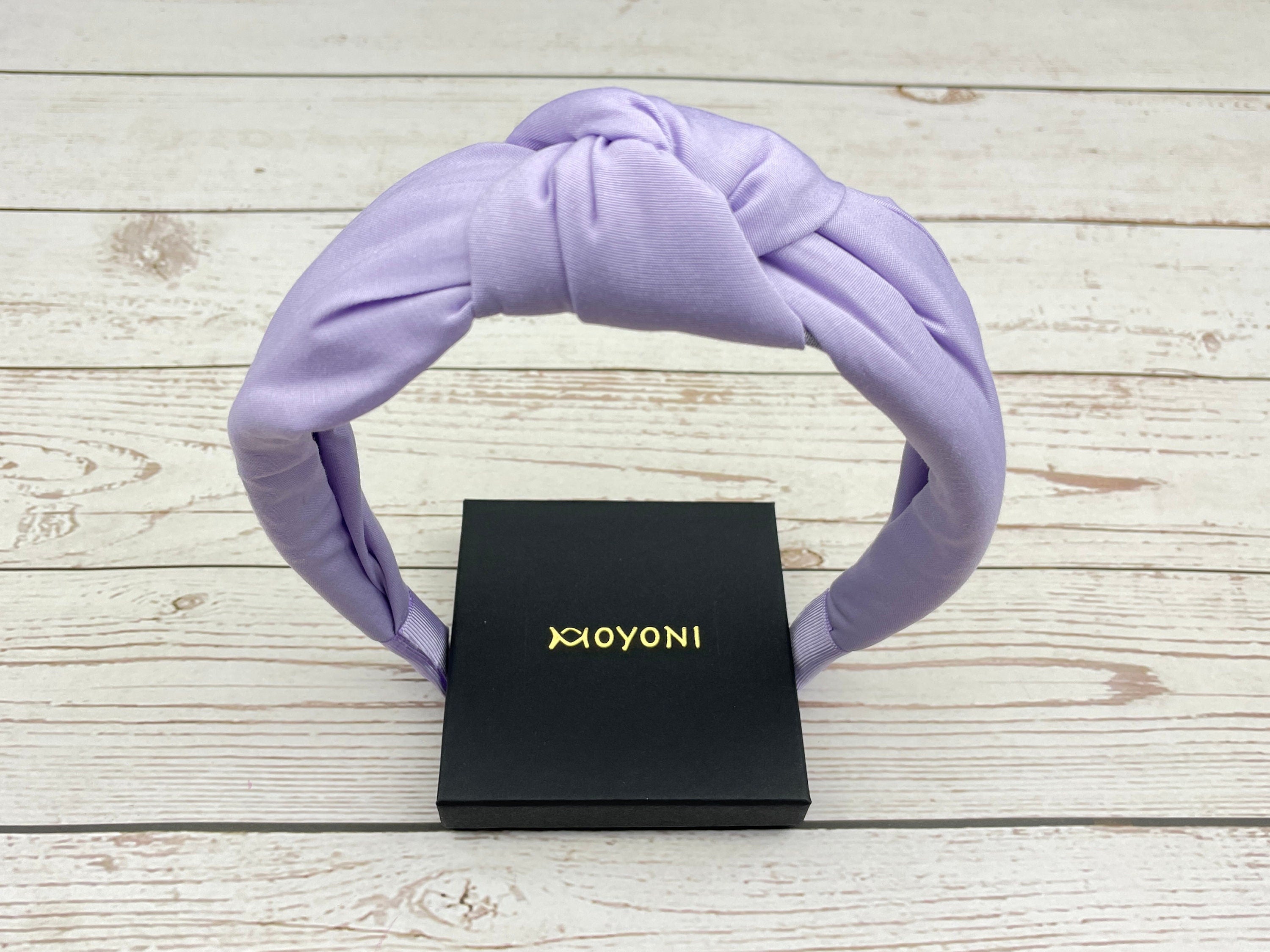 Add a pop of color to your look with this beautiful lavender wide headband.