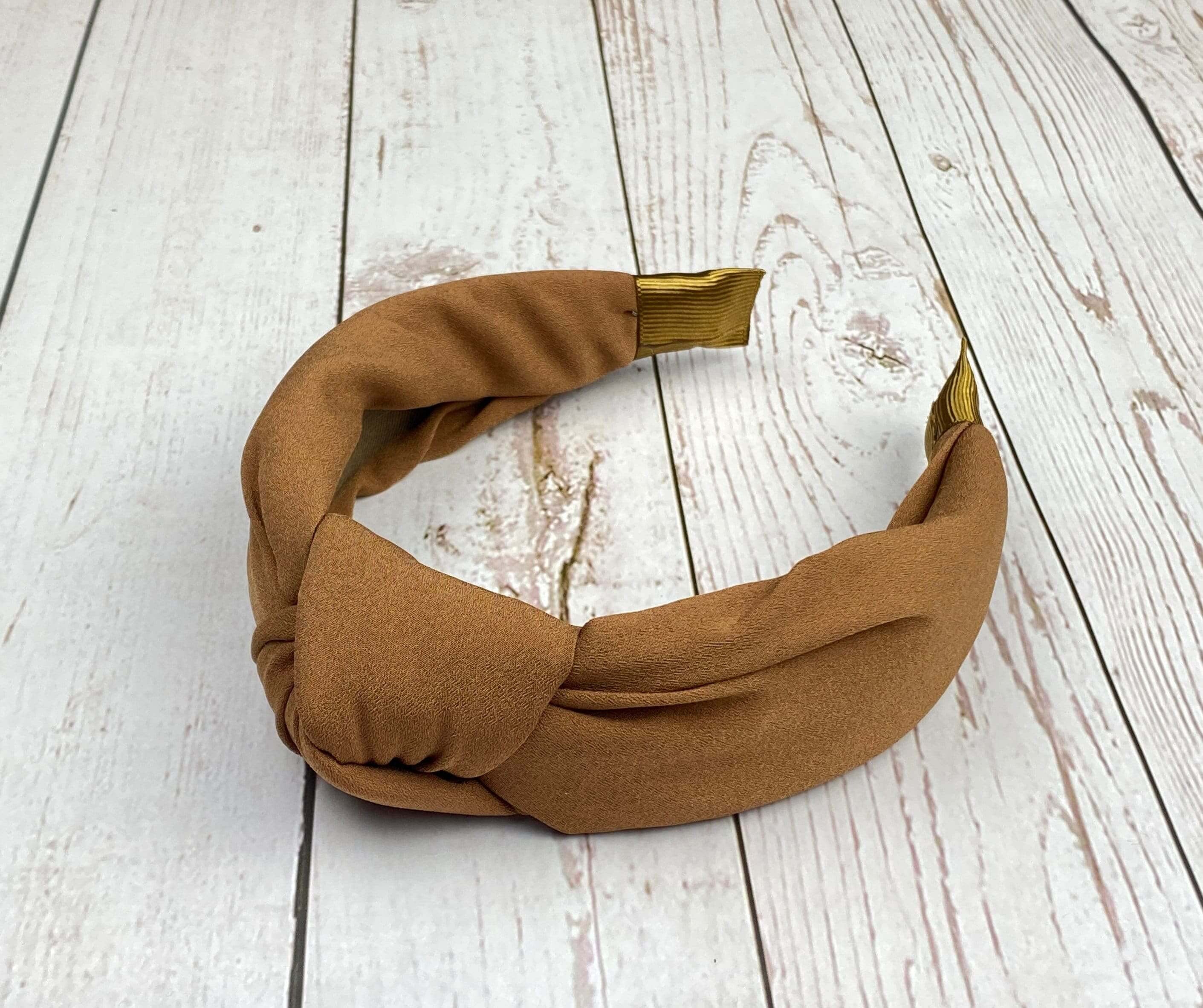 Stay stylish all day long with our versatile and comfortable headbands. From brown padded crepe headband to knotted headband, we have a style that's perfect for you.