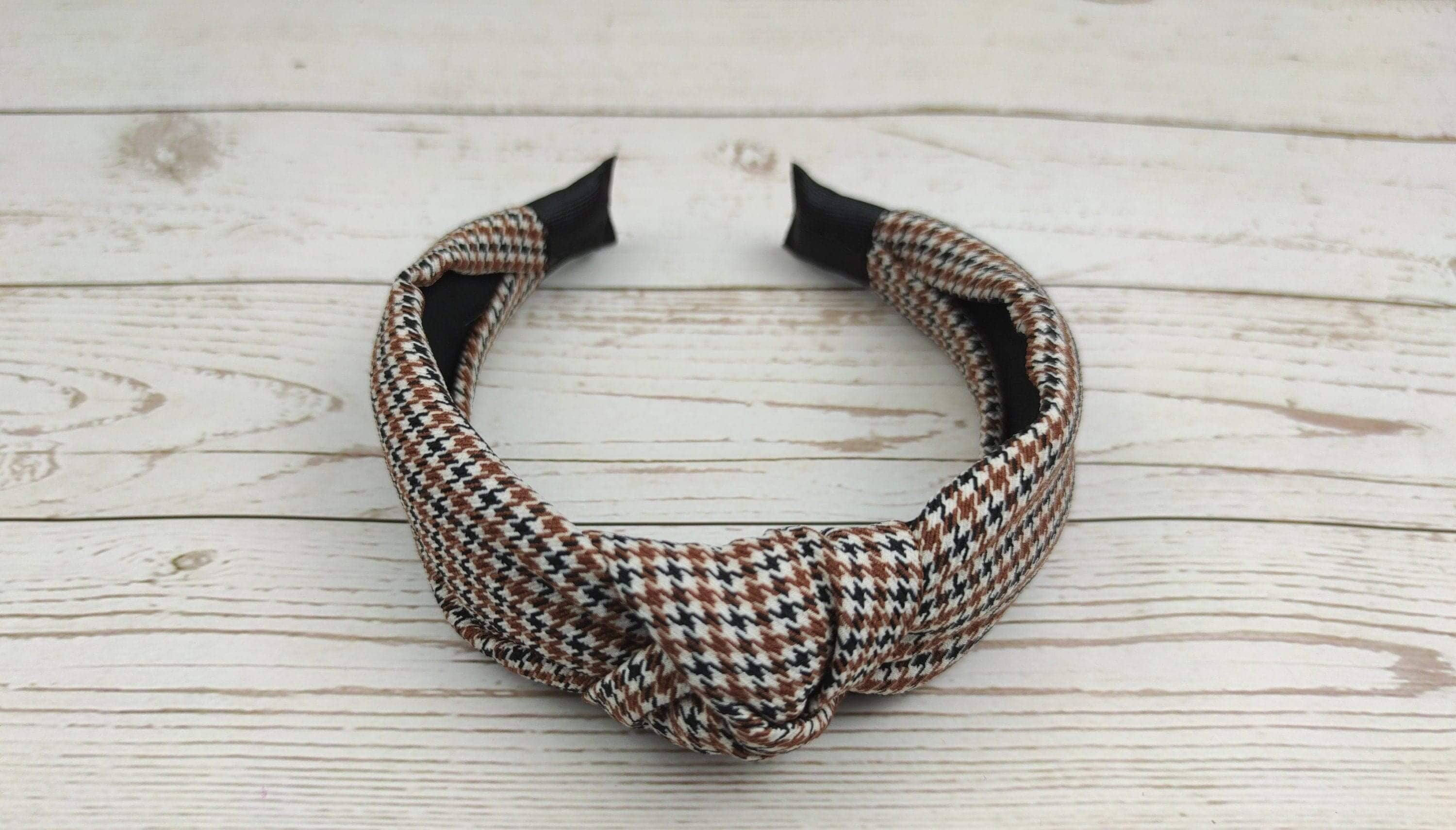 Make a statement with this classic crepe white, black and brown knotted headband. Perfect for women who love to accessorize, it adds a touch of elegance to any college or everyday look.
