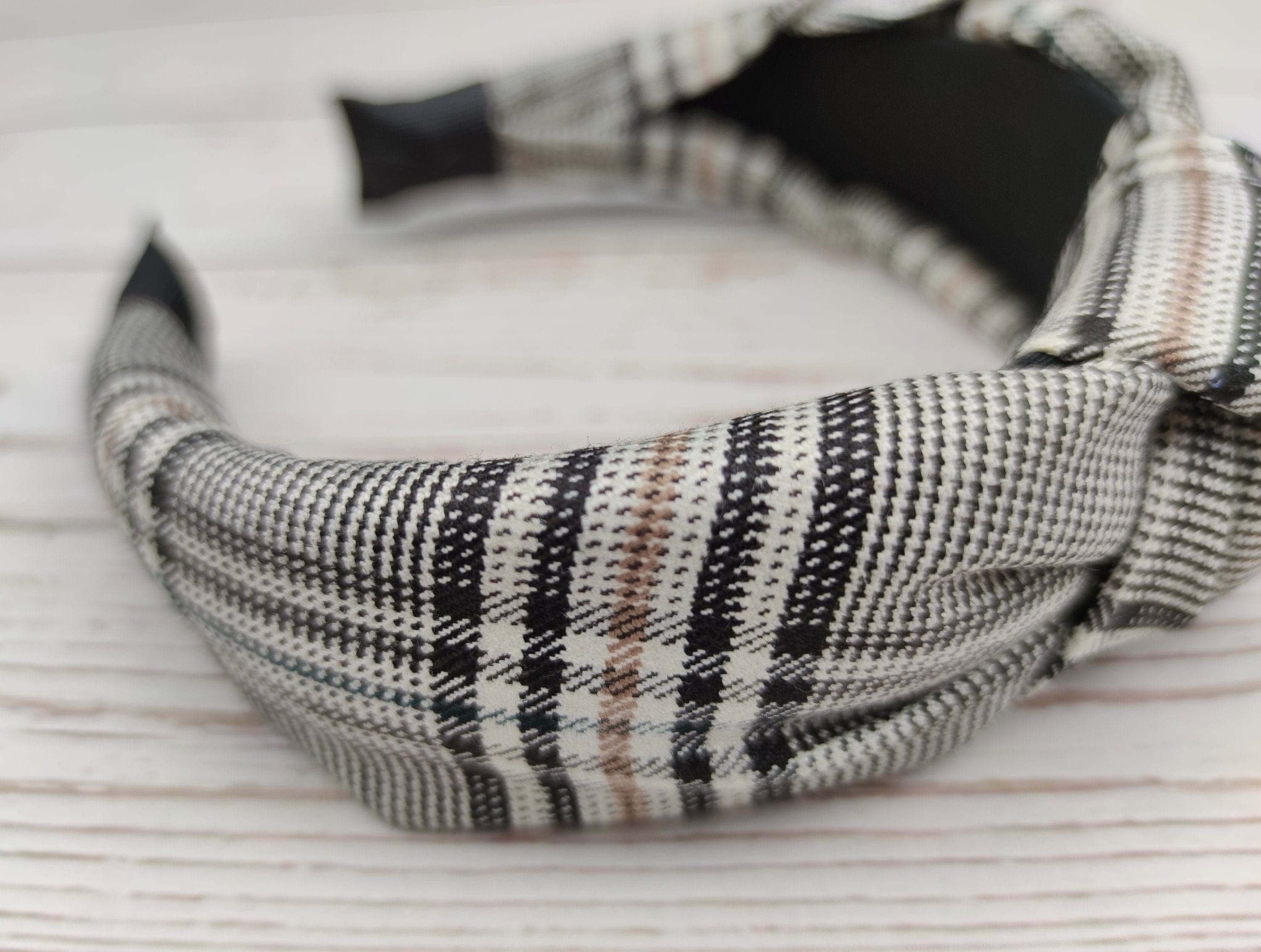 Effortlessly Stylish: Stand out with this chic white and black striped knotted headband. Made from crepe fabric, it's perfect for college girls looking to add a touch of elegance to their outfits.