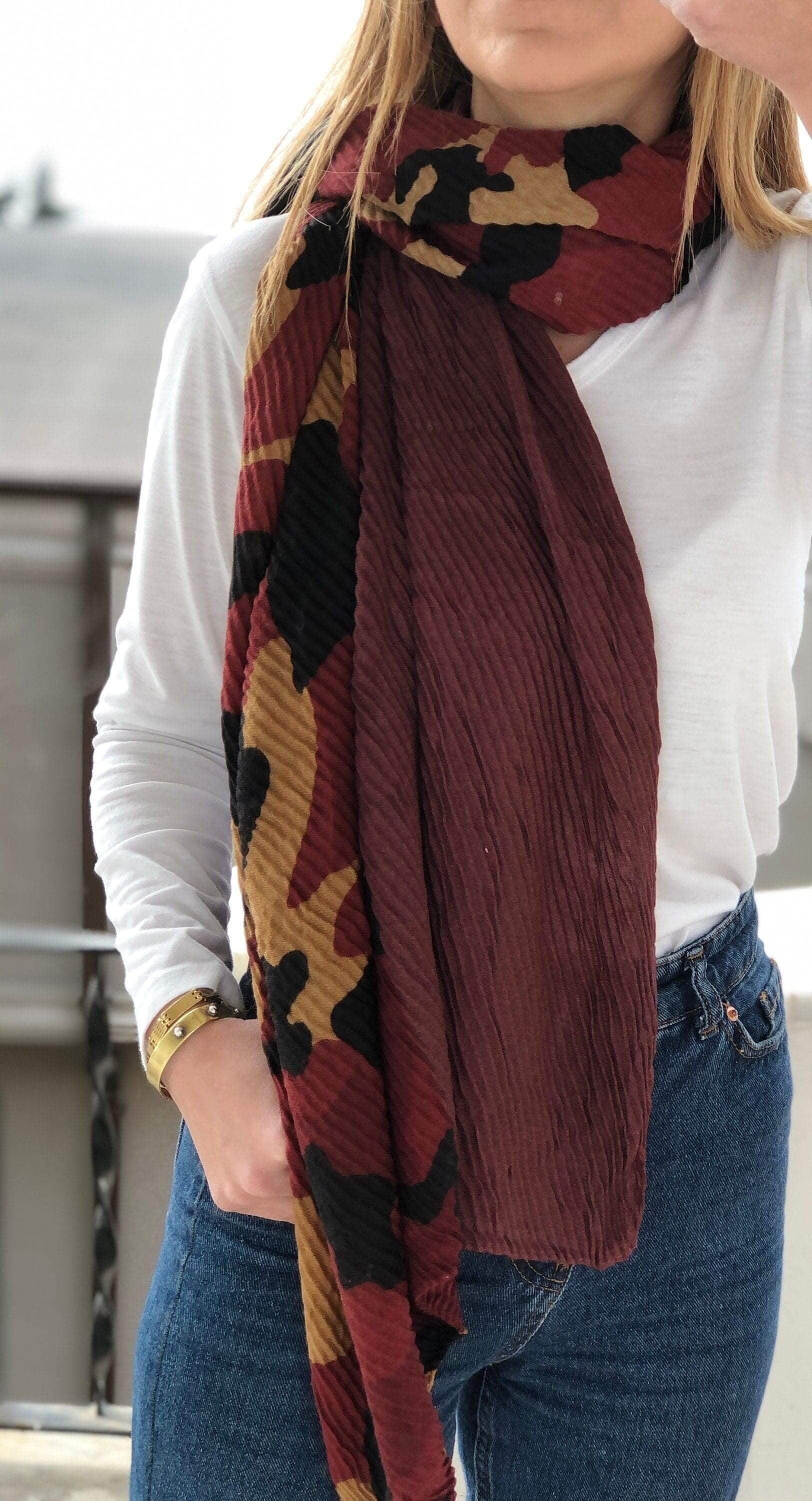 Add a touch of edgy femininity to any outfit with this stunning camouflage scarf in shades of dark pink and brick