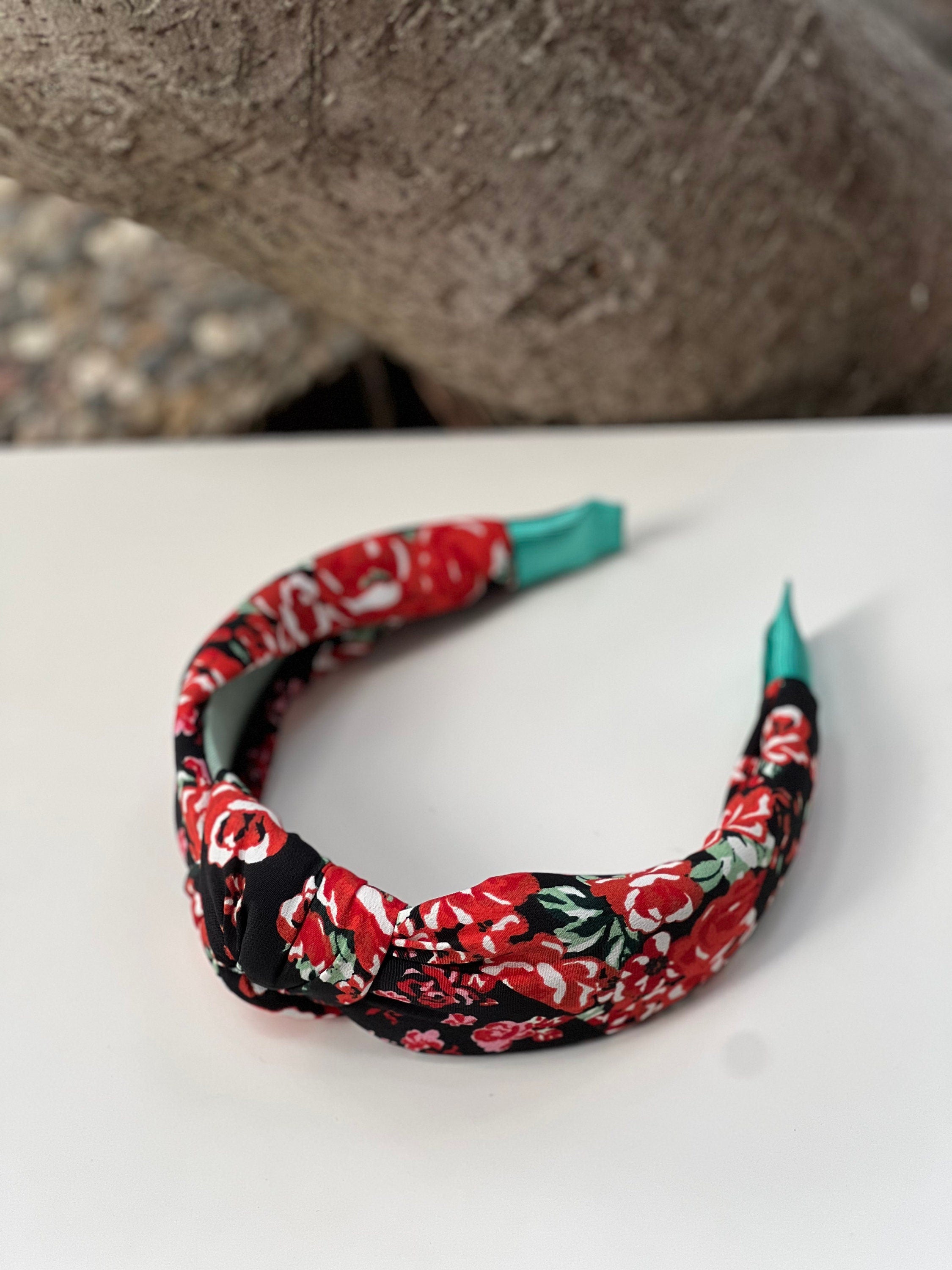 Stylish knotted headband with intricate flower design for a trendy, boho look.