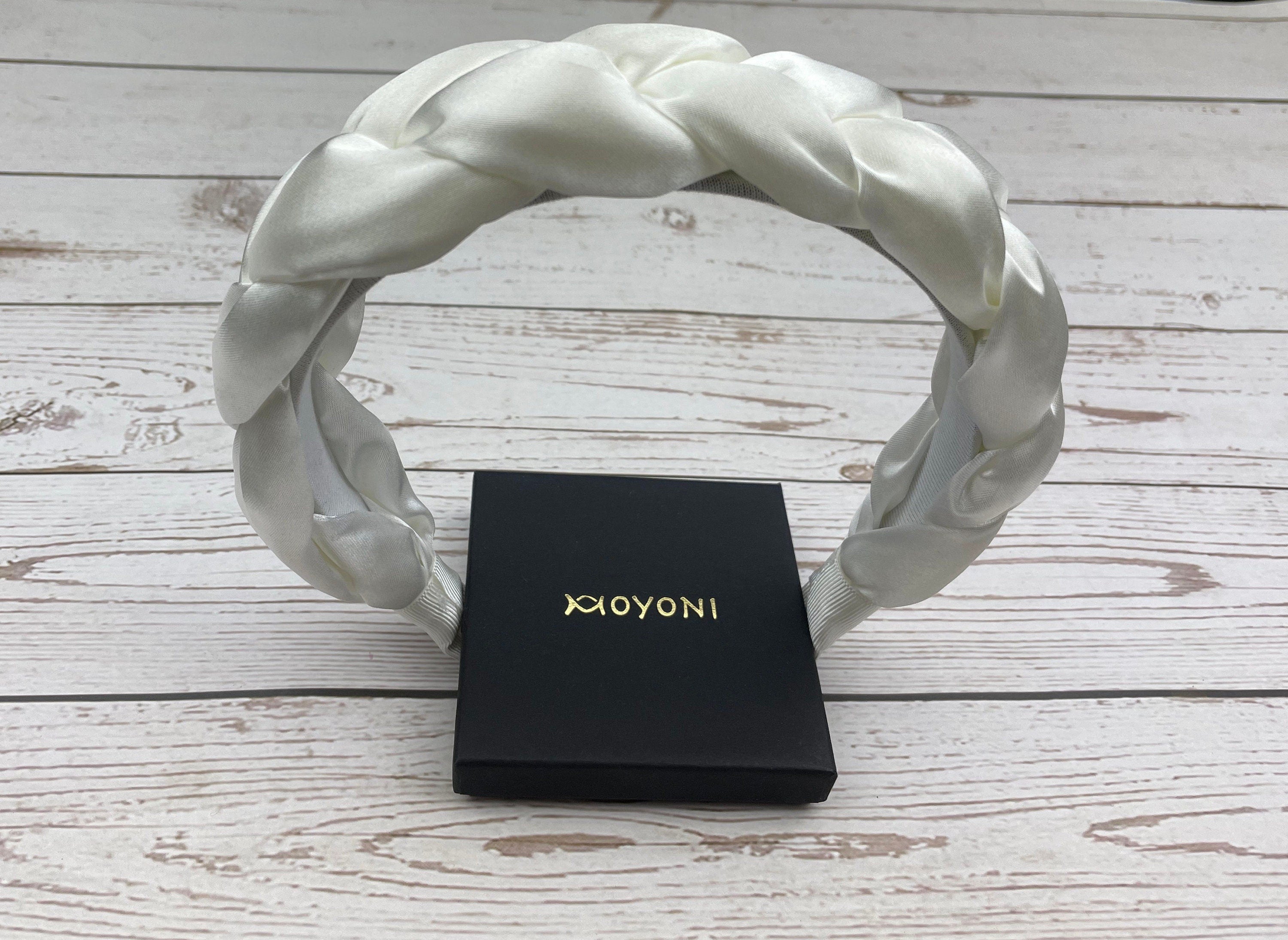 Stay comfortable and on-trend at any celebration with this Snow White Padded Satin Knitted Headband. The perfect accessory for women who love to make a statement with their fashion choices.