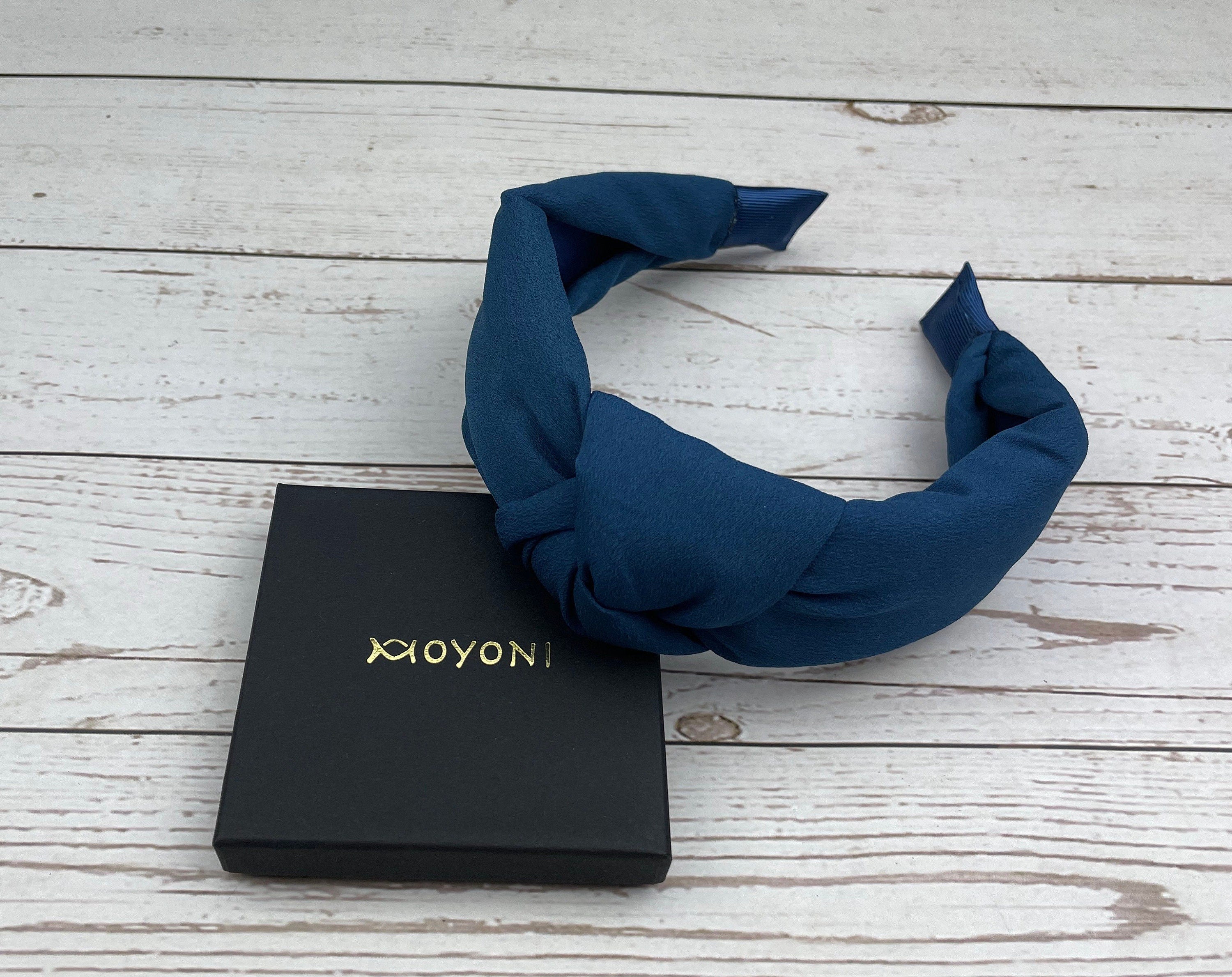 Transform your look with this knotted headband in a rich dark color, perfect for both casual and formal occasions.