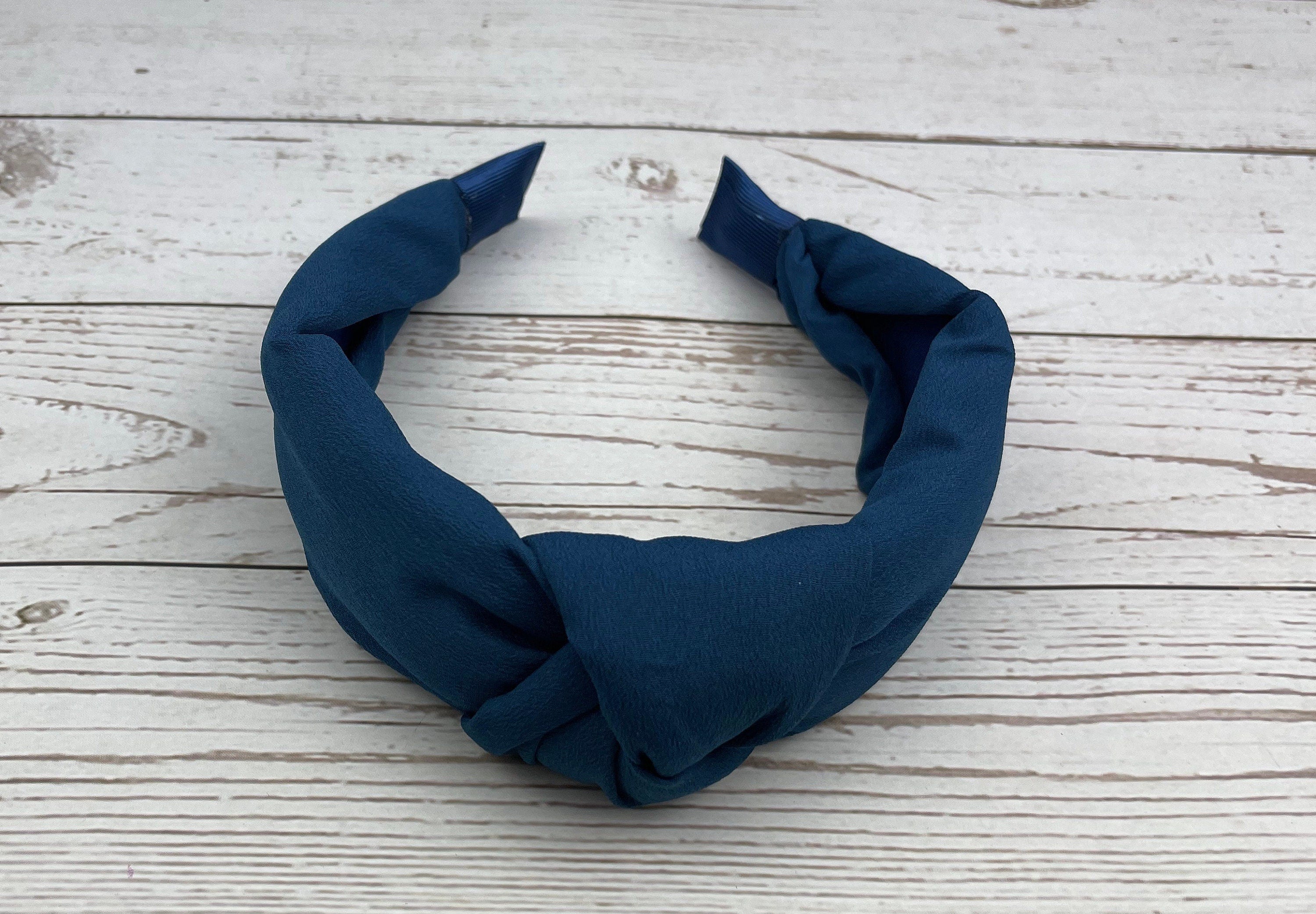 Elevate your hairstyle with this dark blue twist knot headband - a classic and stylish accessory for women.