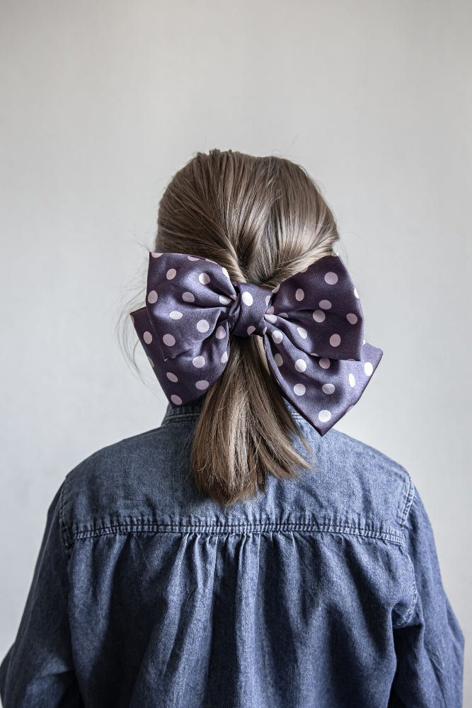 Colorful assortment of hair bows displayed in various sizes and styles, perfect for accessorizing any hairstyle.