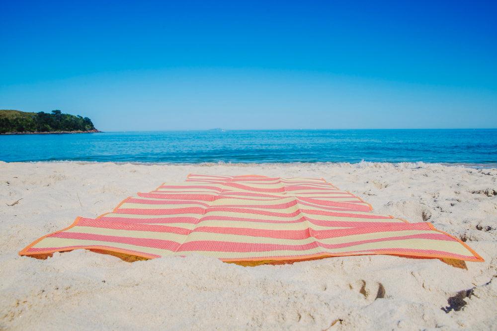 A variety of colorful and intricately patterned peshtemal towels neatly folded in a stack, showcasing their lightweight, absorbent, and versatile qualities, perfect for use as towels, shawls, or blankets.