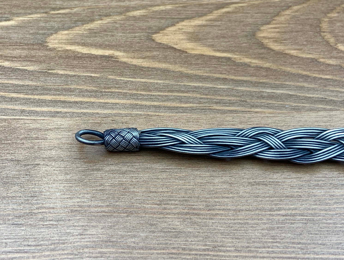 Want to show your love for the sun and the waves? This silver unique chain bracelet is made of tough woven wire, making it the perfect accessory for surfers and beach lovers!