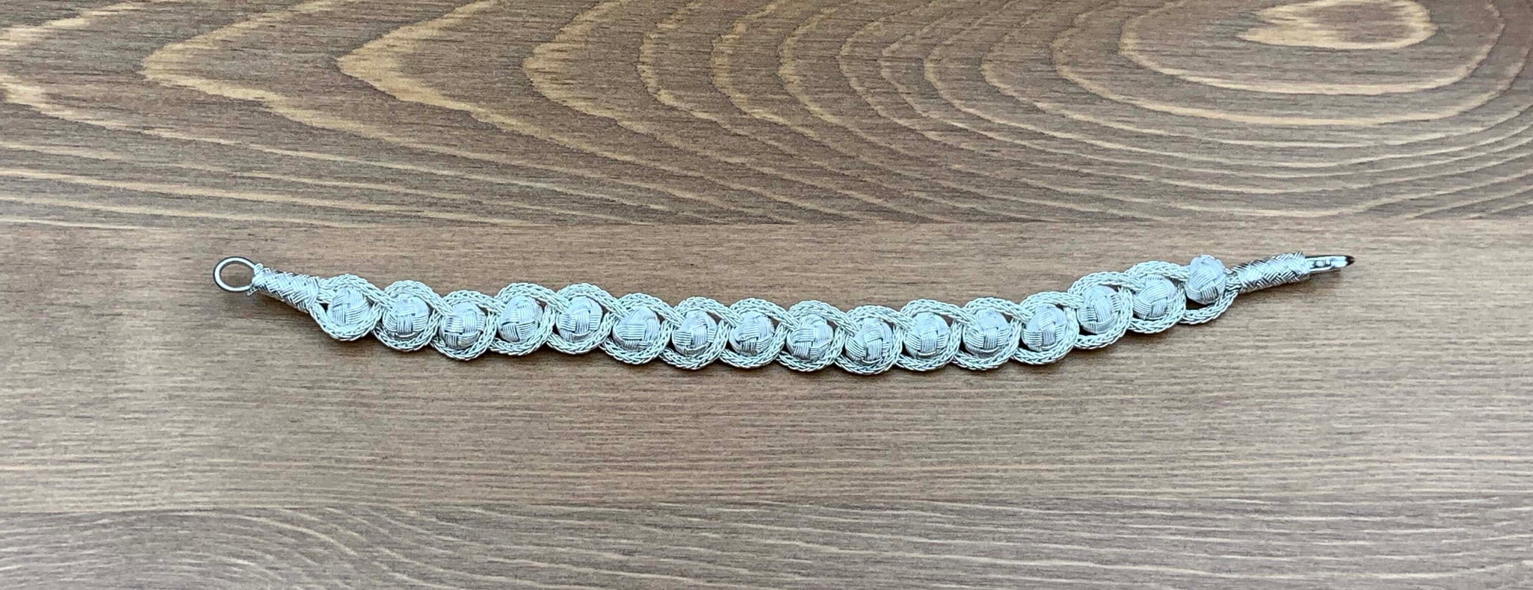 Upgrade your everyday look with this Sterling Bracelet. Made with a sterling charm braid and knitted wire, it is elegant and stylish enough to wear to any special occasion.