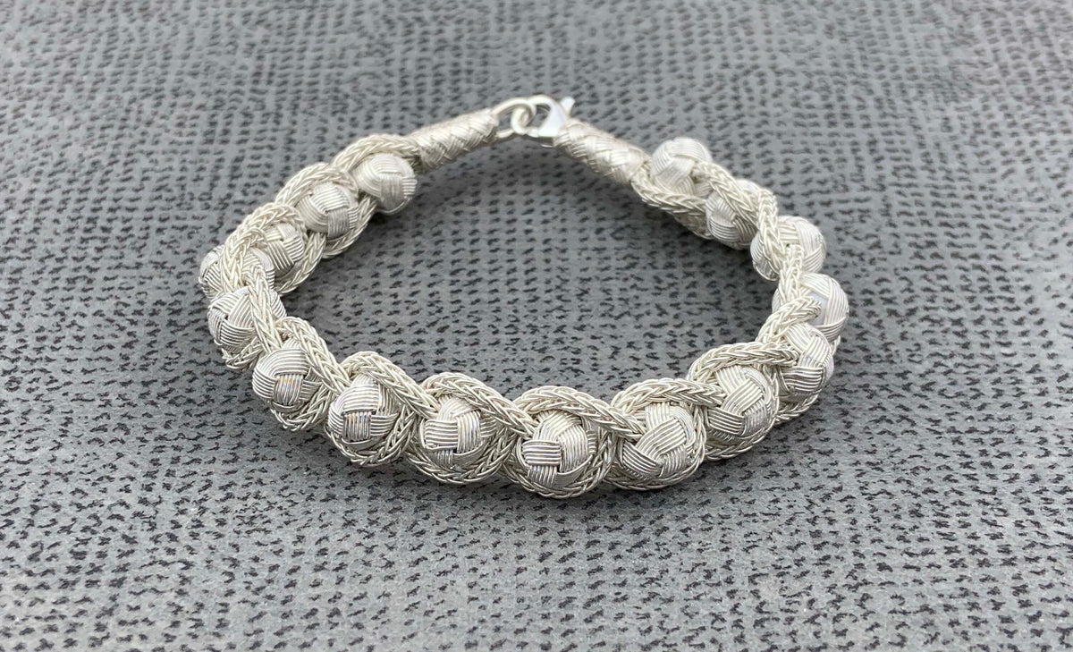 Add a touch of elegance to any outfit with this sterling charm braid knit wire jewelry. It's perfect for a 70s bohemian style, or to wear on any special day!