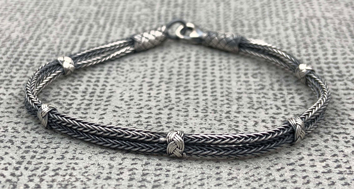 Make sure your man doesn't go unnoticed this Father's Day with this stylish and unique layered bracelet! He'll love the attention to detail that went into crafting it, from the sterling silver clasp to the woven layers.