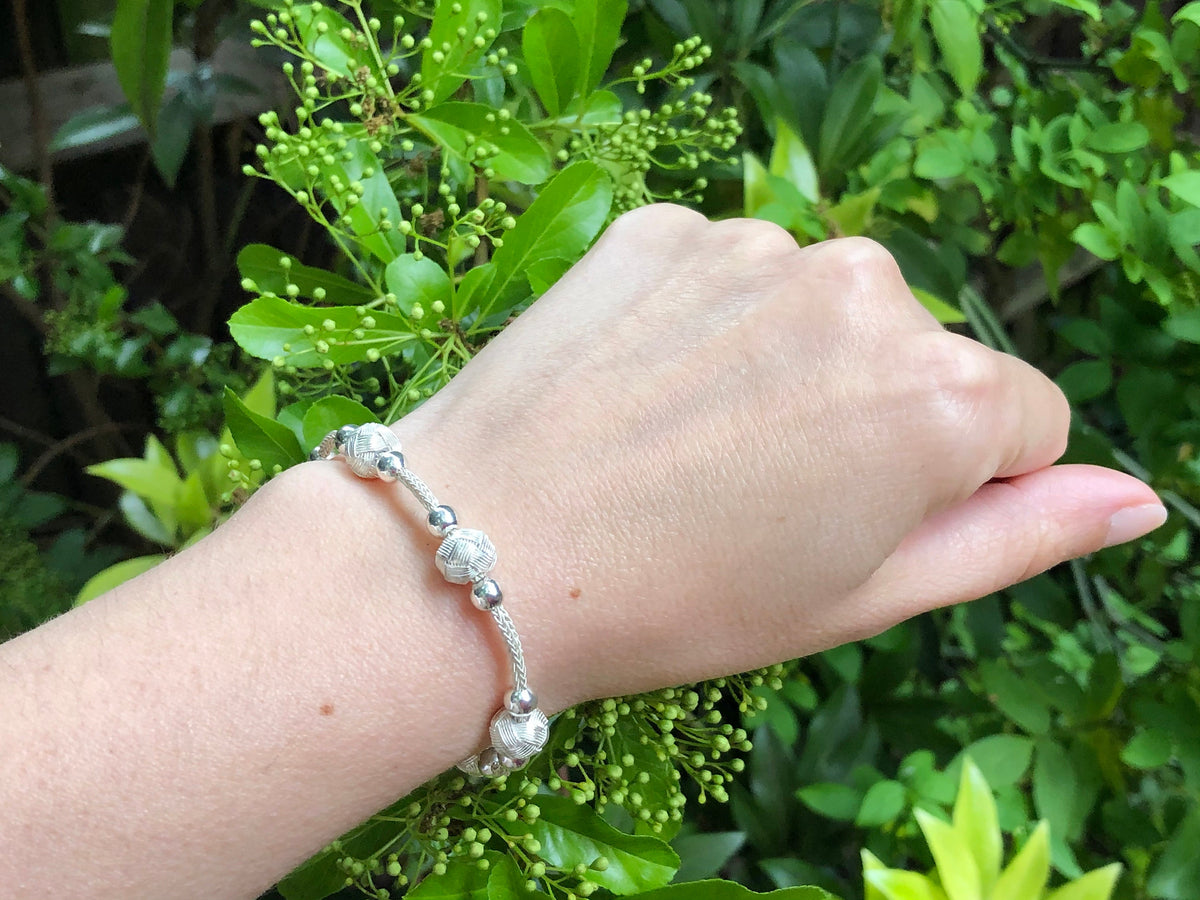 This Unisex Bracelet is the perfect accessory for anyone who wants to add a little bit of personality to their outfit. It's made from high-quality materials and features a silver ball charm on it.