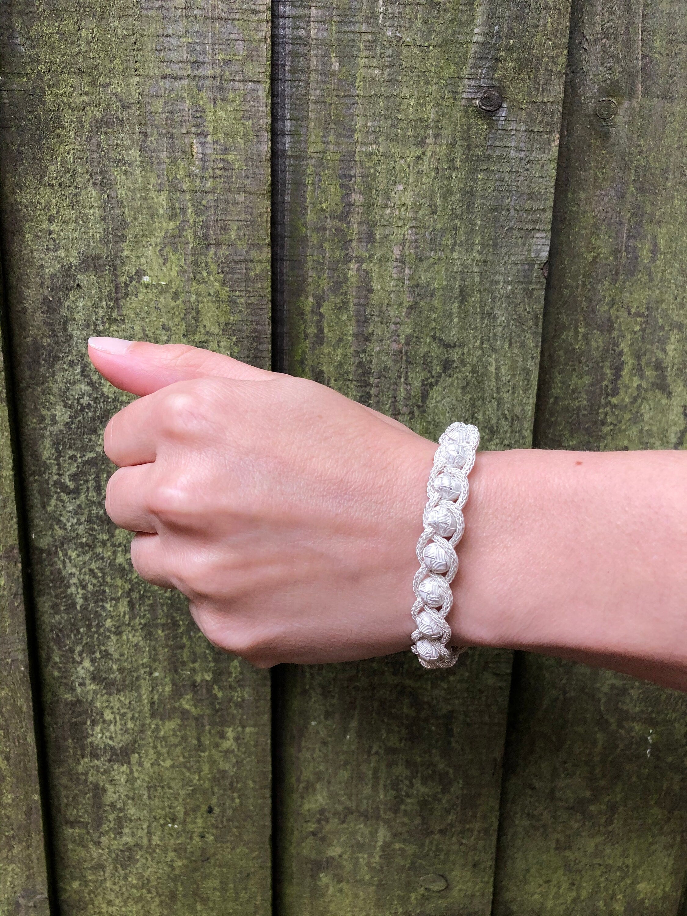 Celebrate any special occasion with this sterling charm braid knit wire jewelry bracelet. Made from high-quality materials, it is perfect for anniversary gifts, silver wedding presents, or just because.