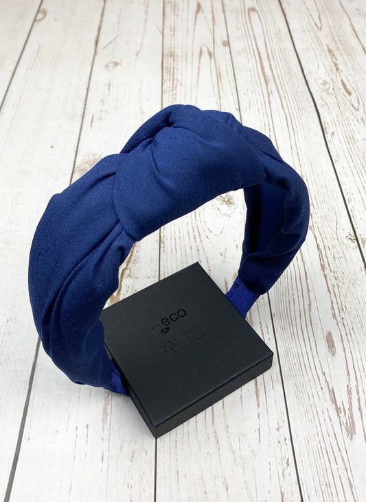 Stay comfortable and fashionable with this navy blue padded headband, perfect for any outfit.