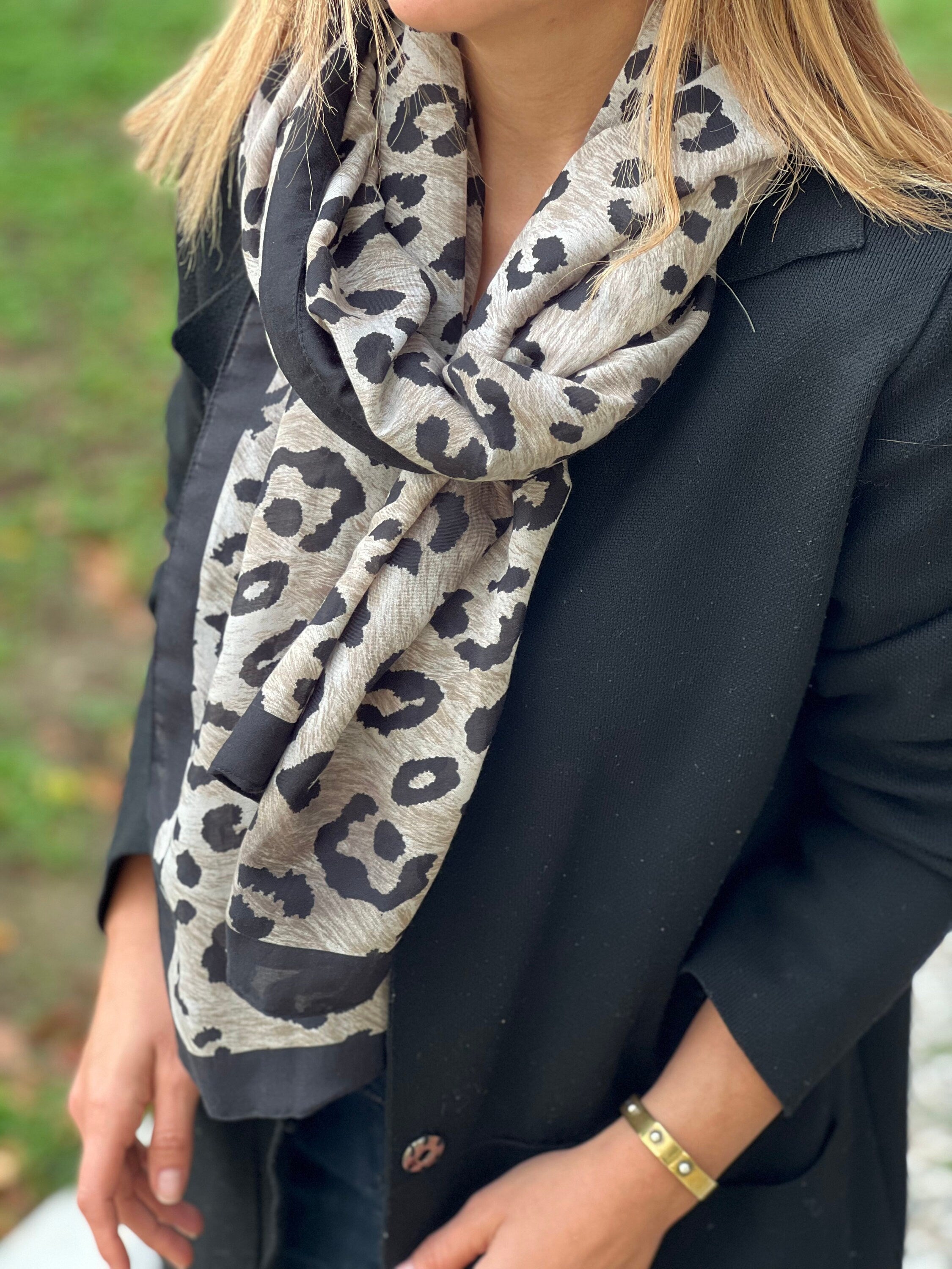 Stay stylish and warm this winter with this black and beige leopard printed shawl. A great addition to any outfit, this animal print scarf is soft and comfortable