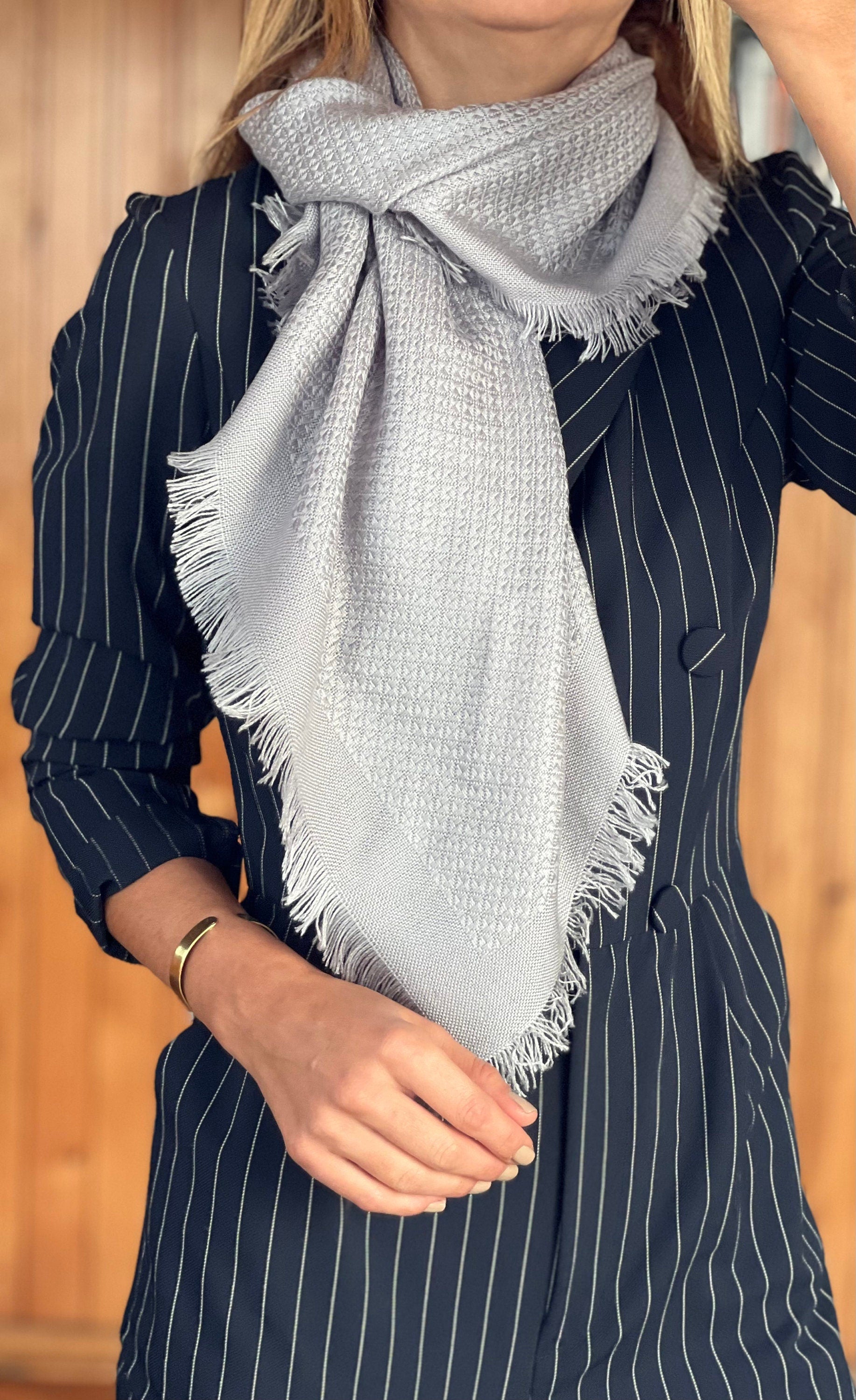 Elevate your accessory game with this stylish and practical light grey wool blend scarf.