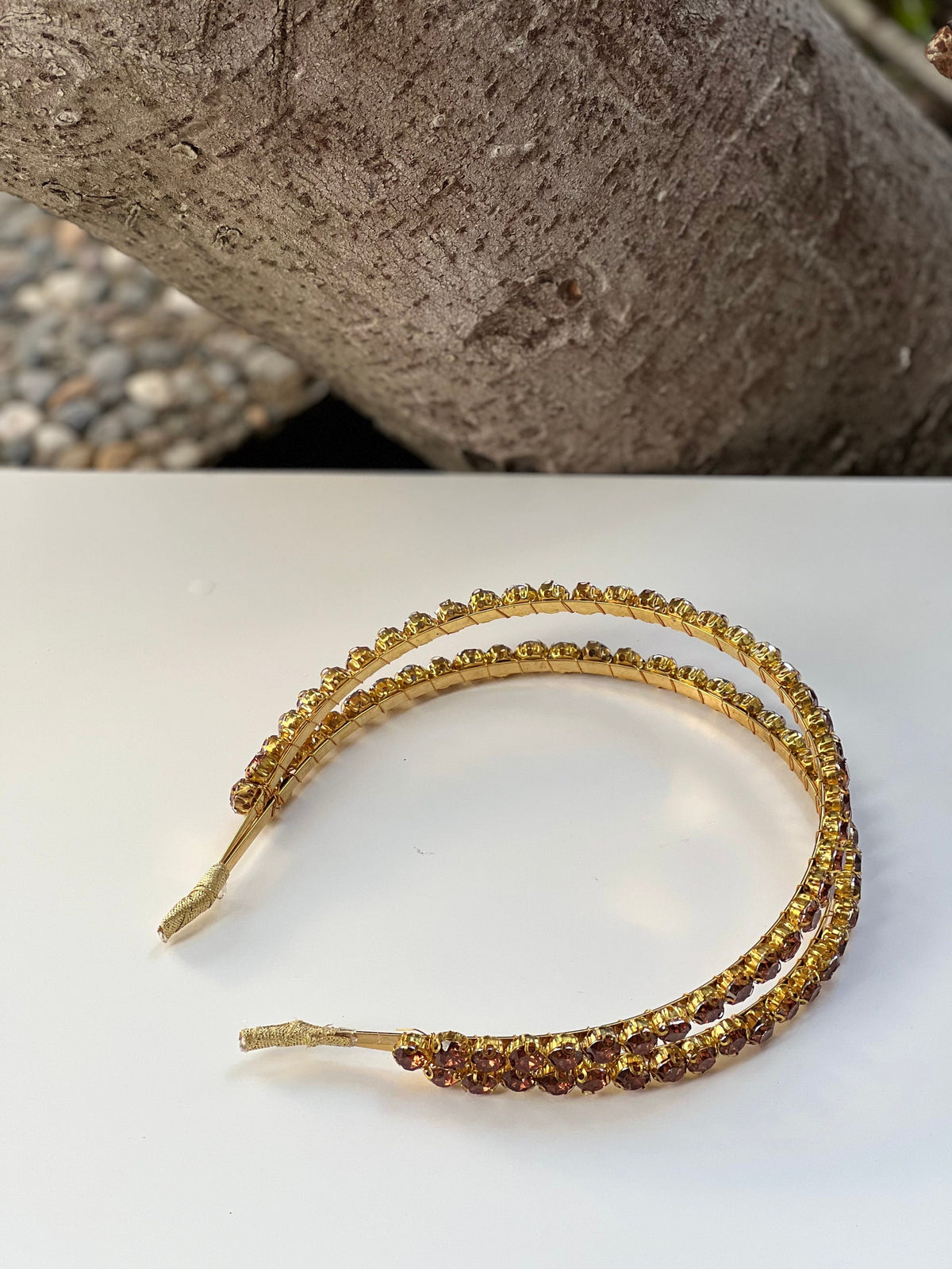 Elevate your bridal style with this gorgeous gold and brown crystal headband. The intricate metal design and shimmering crystals will make you feel like a true goddess on your wedding day.