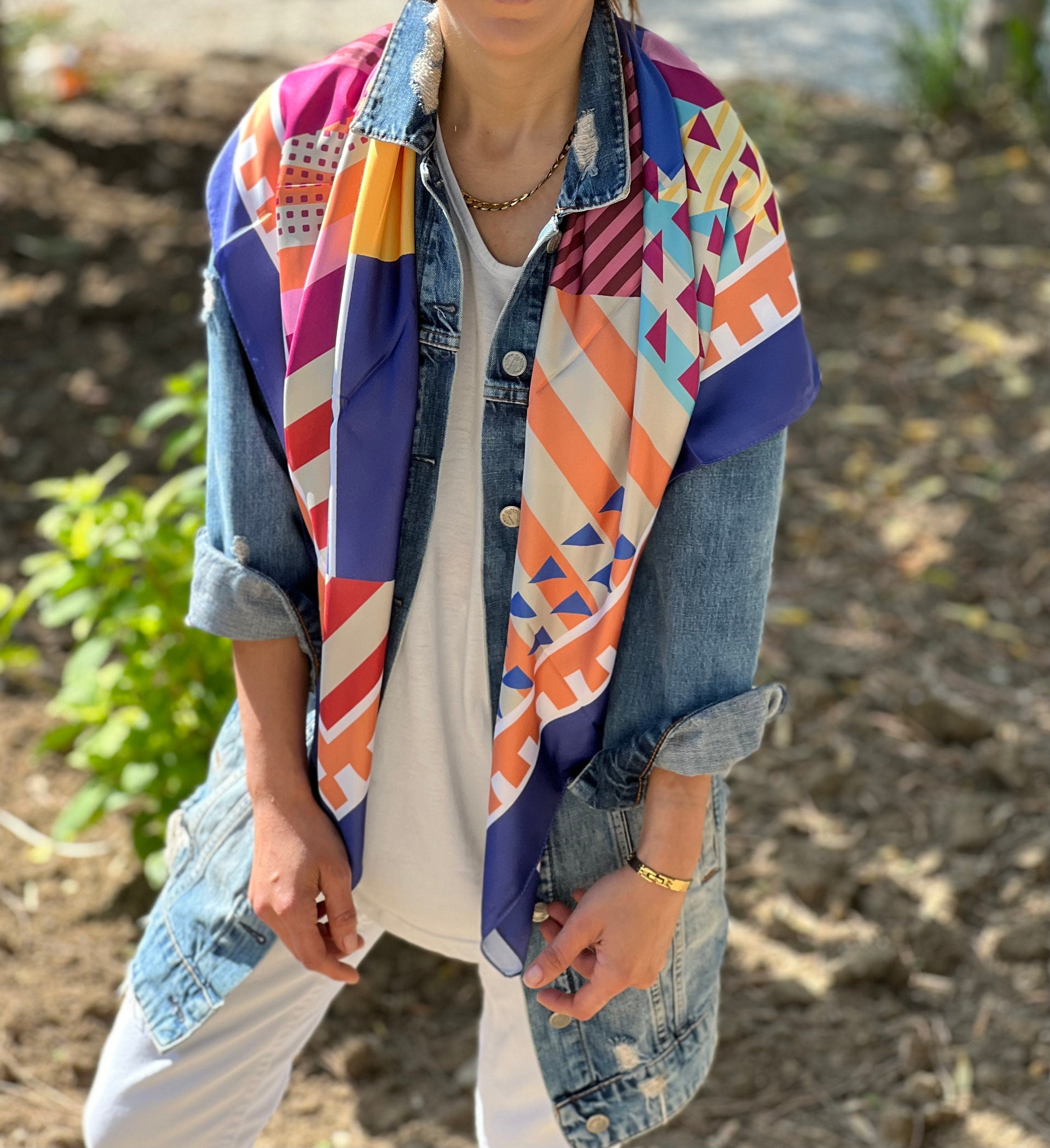 Add a pop of color to your summer wardrobe with this vibrant multicolor silk satin blend scarf.