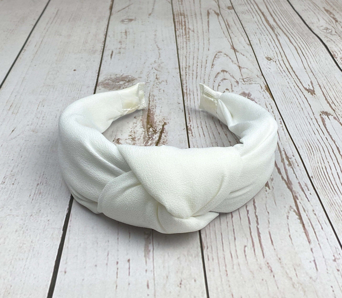 Add a touch of sophistication to your look with this snow-white padded headband.