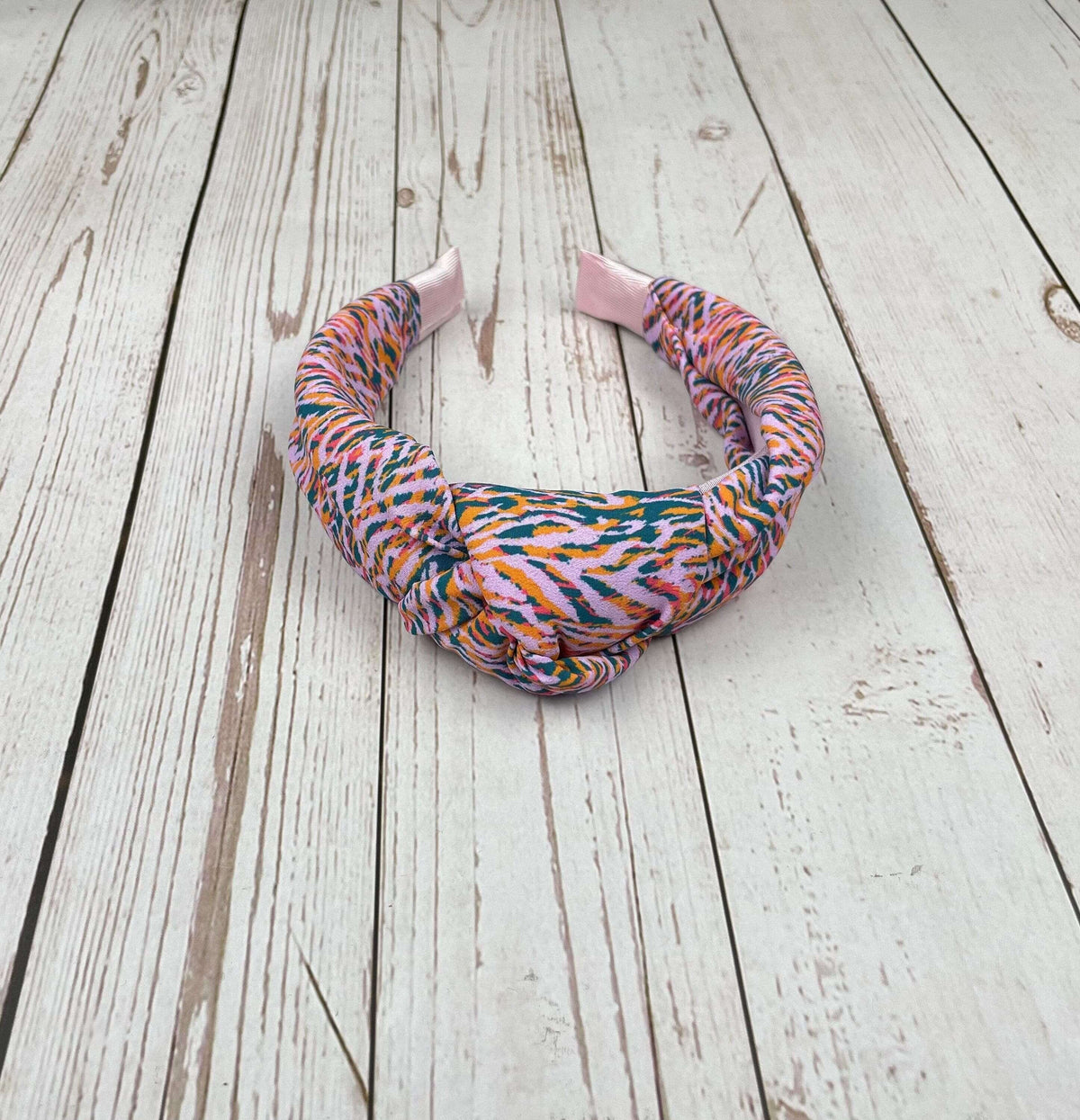Stay on-trend with this Pink Green Striped Headband, featuring a colorful leopard pattern
