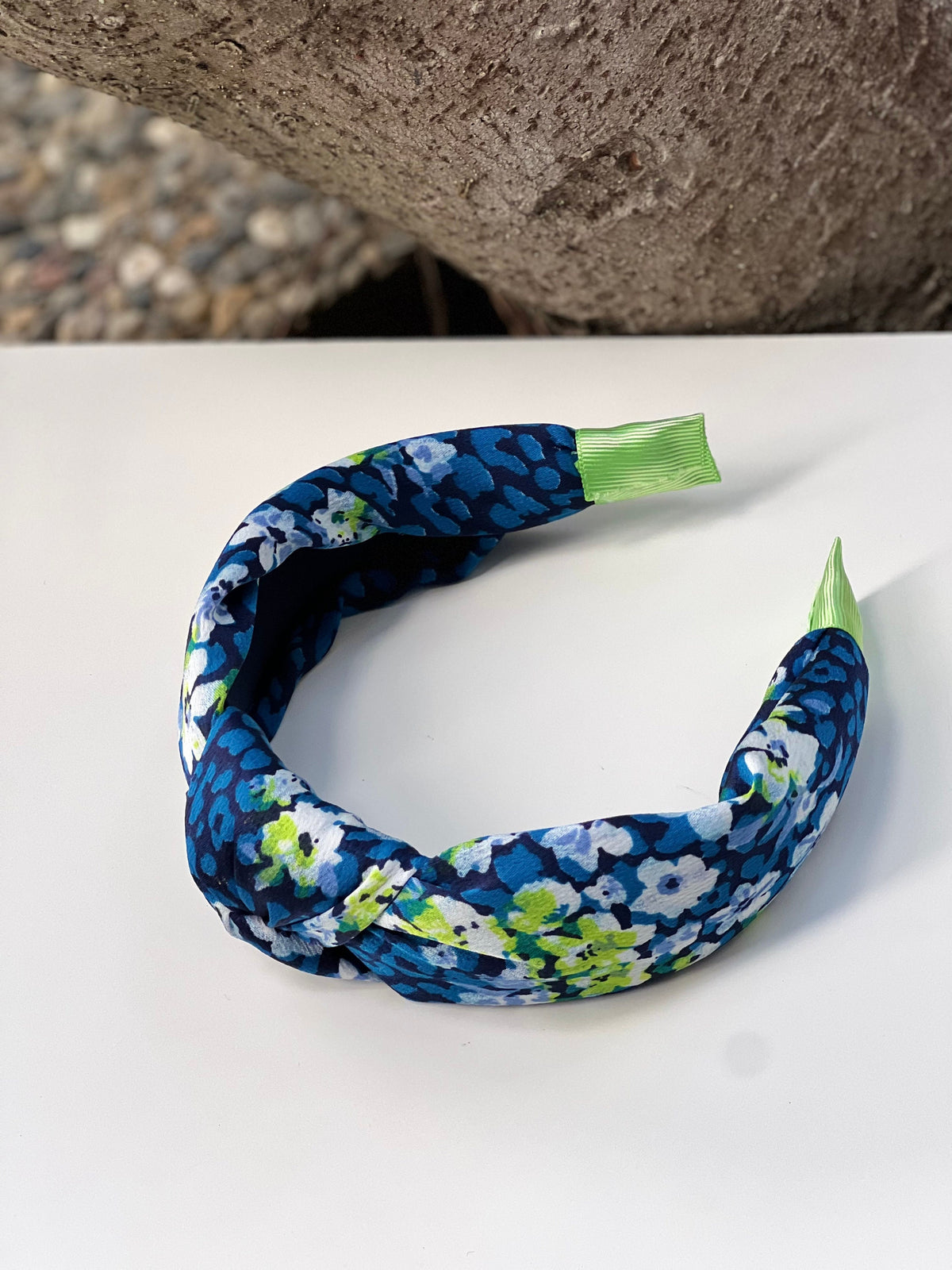A Shiny Knotted Headband in a beautiful floral pattern that's perfect for adding some flair to your hair.