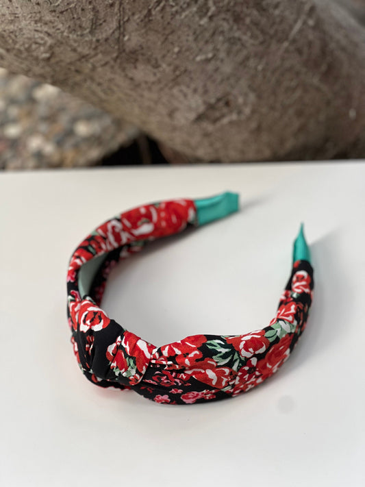 Stylish knotted headband with intricate flower design for a trendy, boho look.