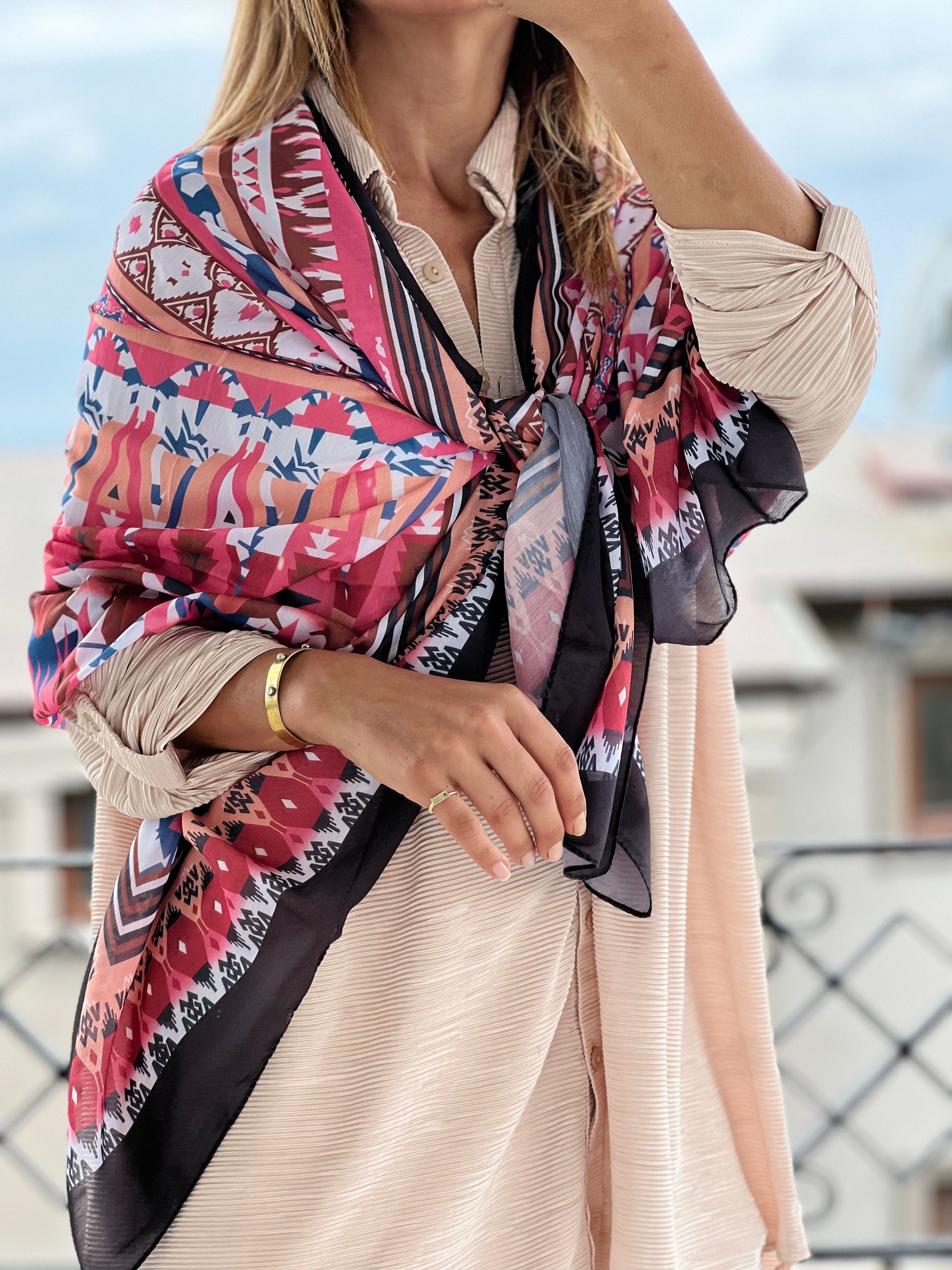 Stay warm and stylish with this Large Cotton-Viscose blend voile scarf in a vibrant pink, green, and black color scheme. Ideal for all seasons, this scarf features a unique and authentic pattern that is perfect for layering.