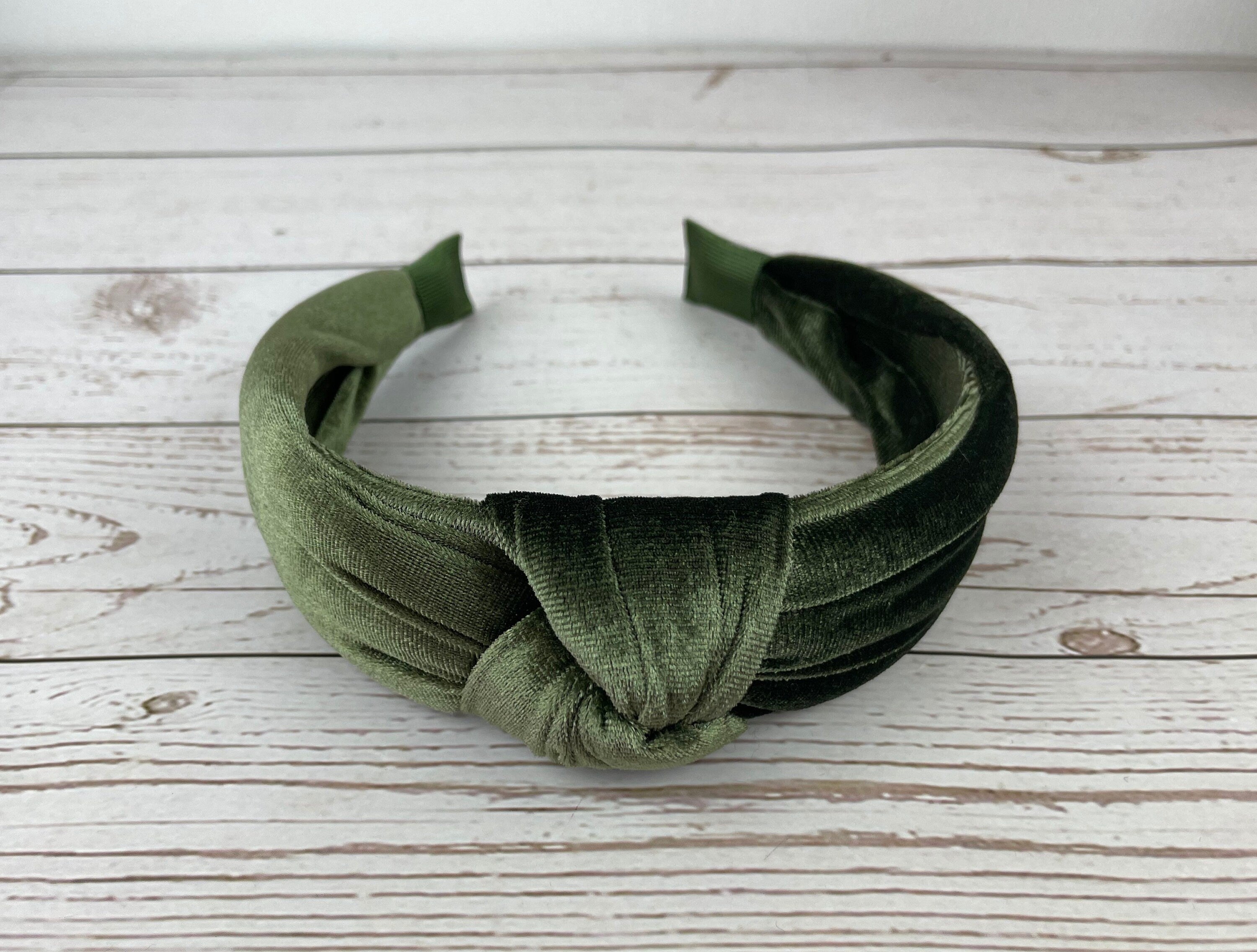Braided girl&#39;s hairband in a beautiful pea green color - a must-have accessory for any fashion-forward young lady.
