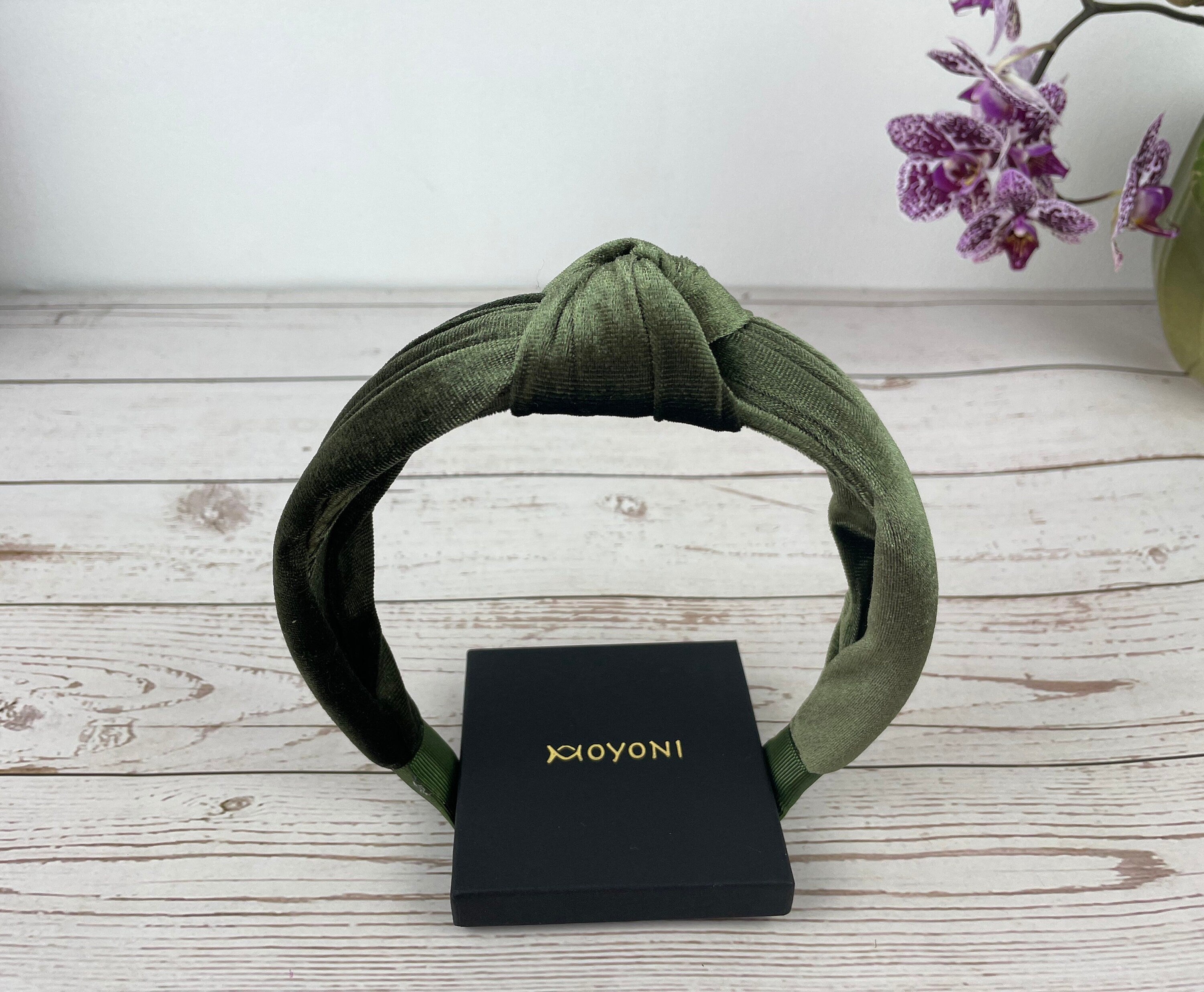 Elevate your look with this chic army green knotted headband - a fashionable accessory for any occasion.