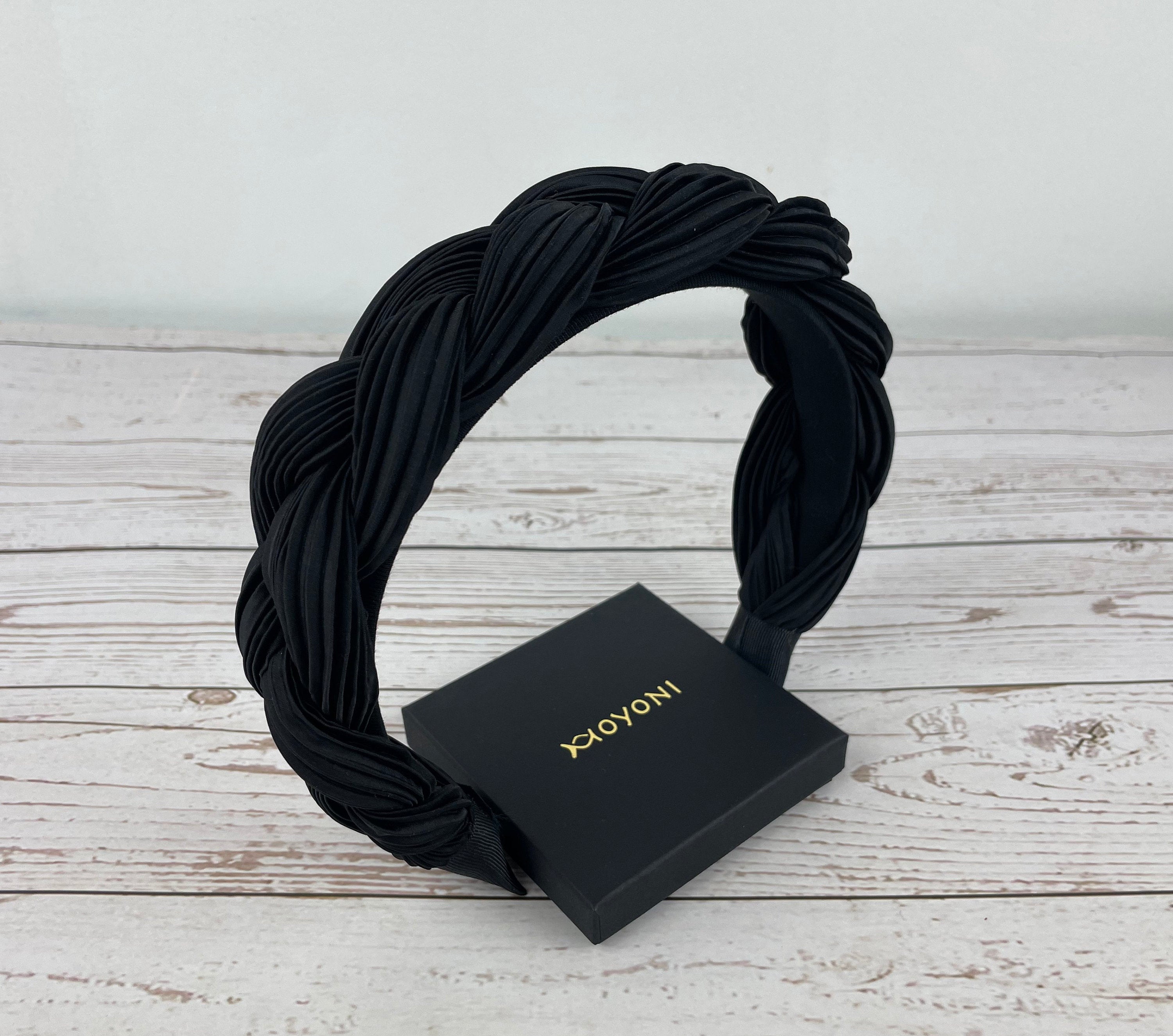 A wide velvet headband in black, offering a luxurious and comfortable accessory option for various occasions, from casual to formal.