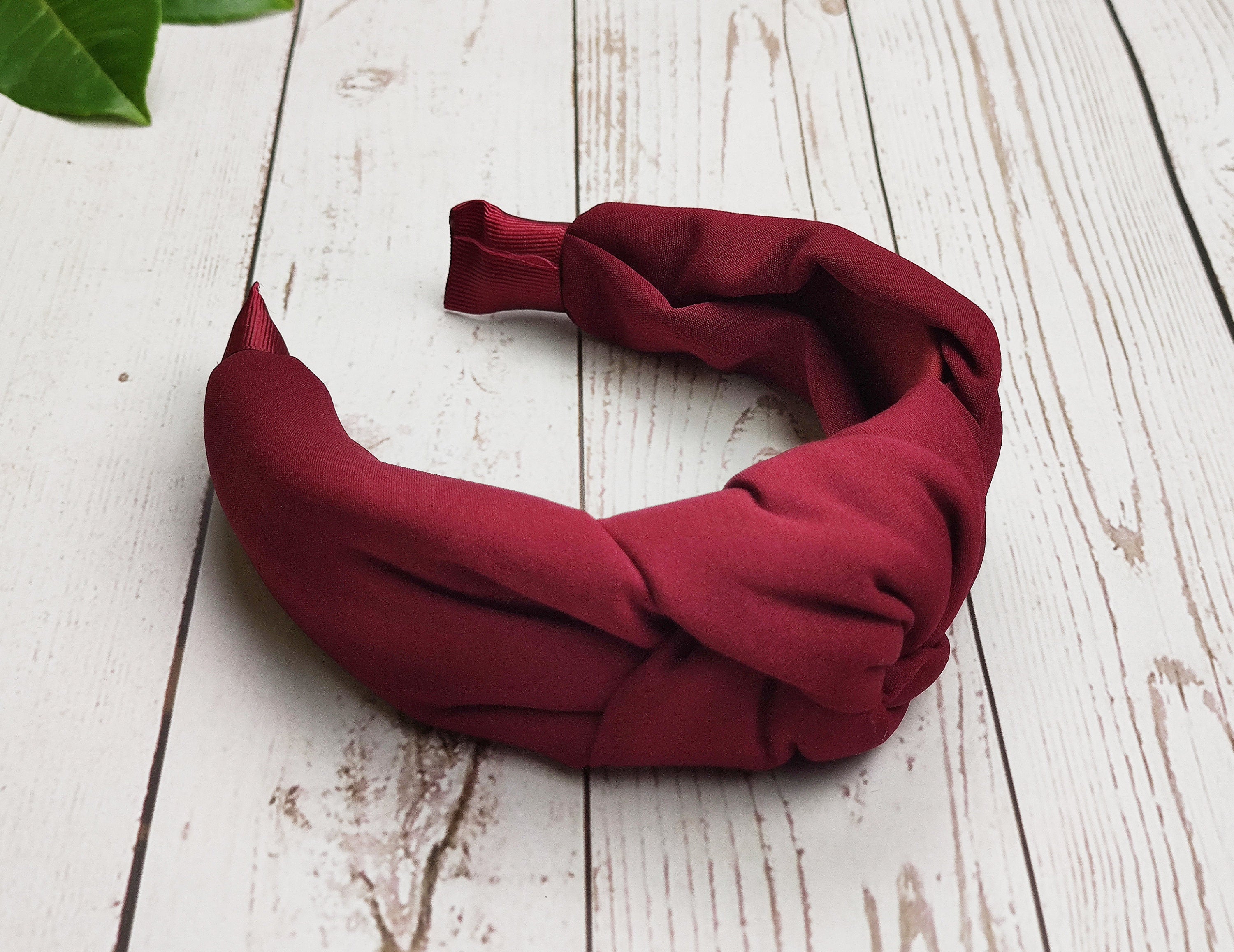 Make a bold statement with our Dark Red Twist Knot Headband. Perfect for adding a pop of color to your hair game.