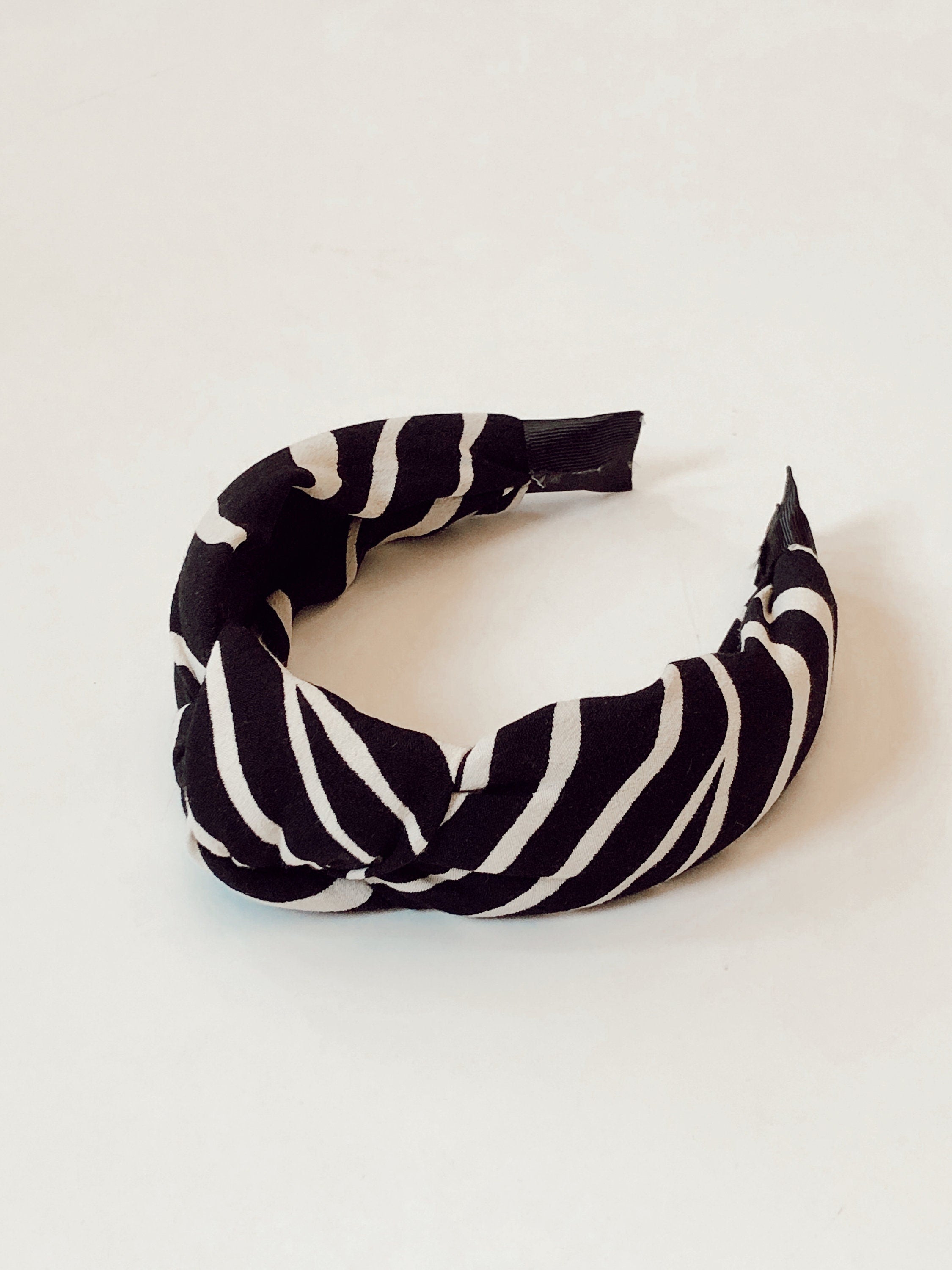 Upgrade her hair game with this must-have knotted headband, designed with a chic zebra pattern.