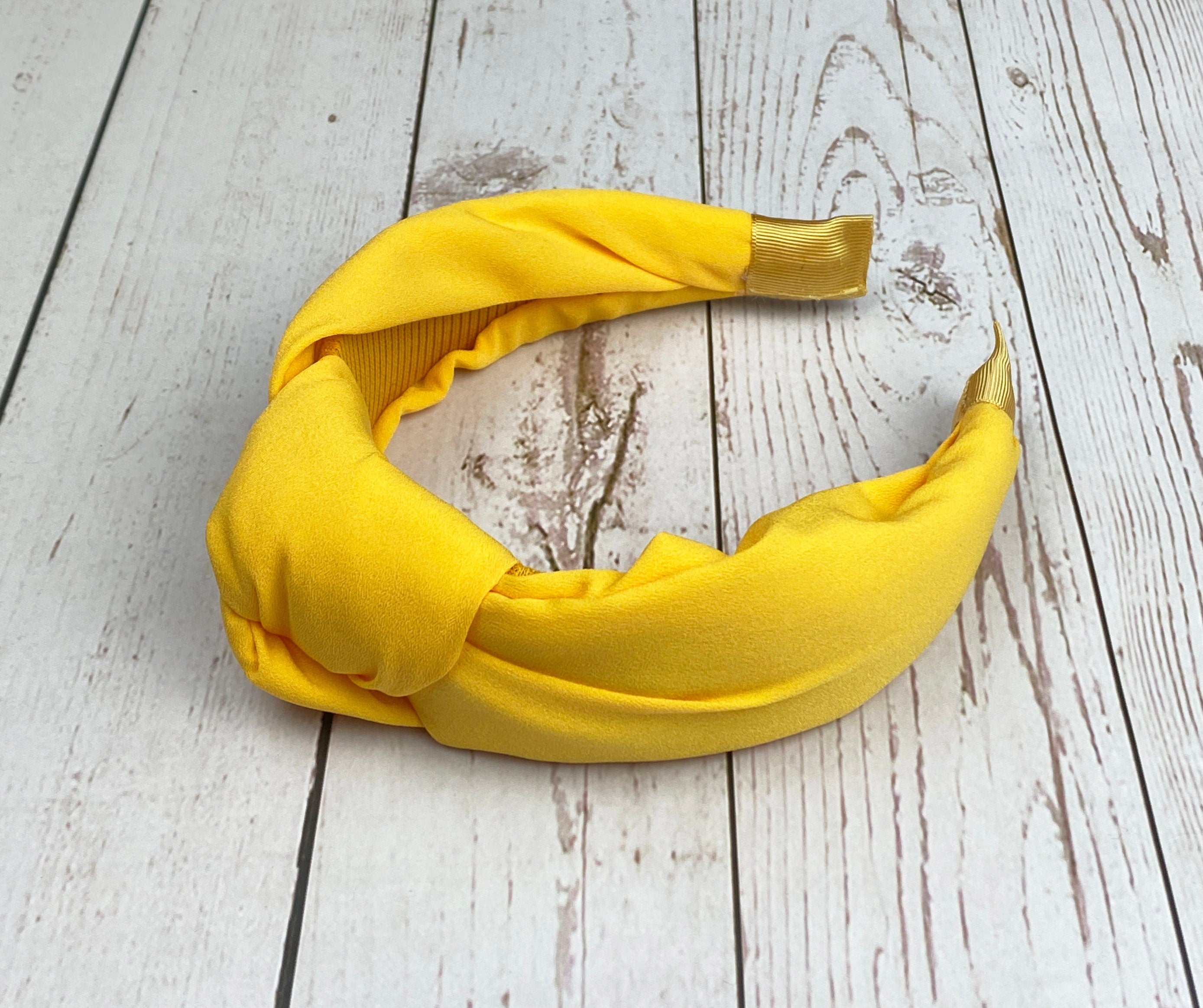 Looking for a statement piece to complete your outfit? Look no further than our Yellow Headband! With its bold hue and eye-catching design, this headband is sure to turn heads.