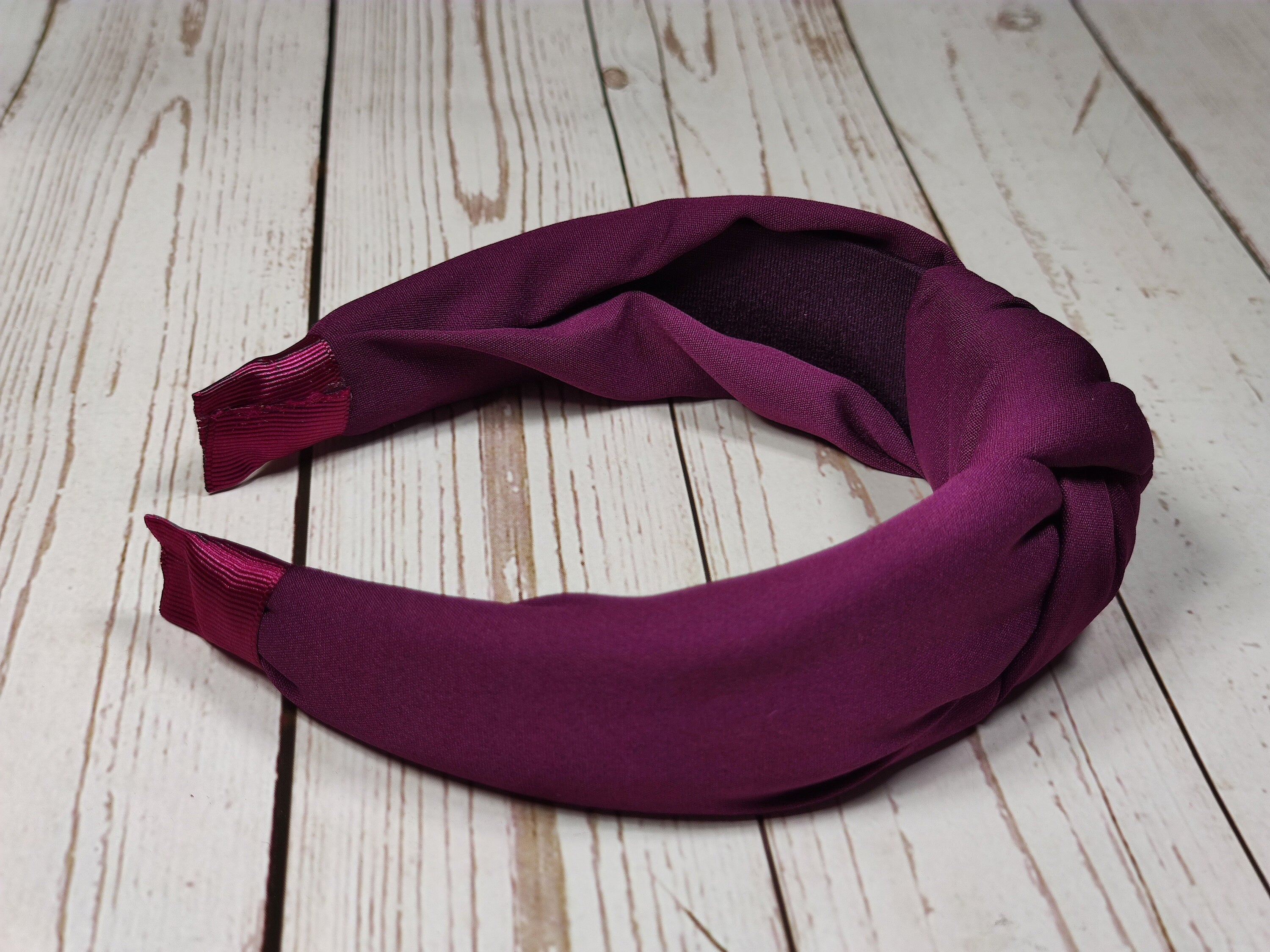 Add a pop of color to your look with this fashionable maroon-colored headband. Made from soft and comfortable viscose crepe material, this headband is perfect for day or night.