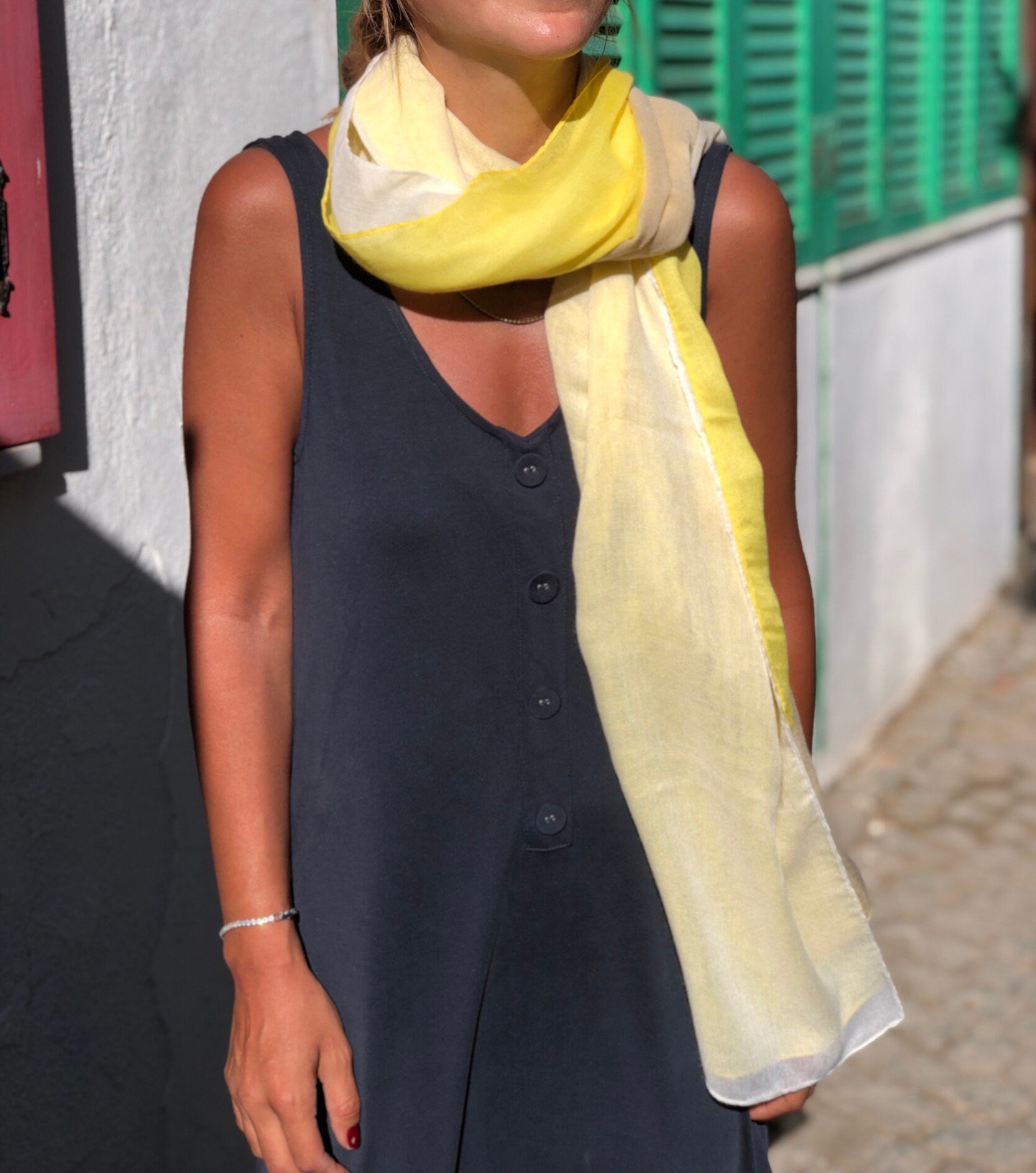Add a pop of color to any outfit with this gradient yellow cotton scarf