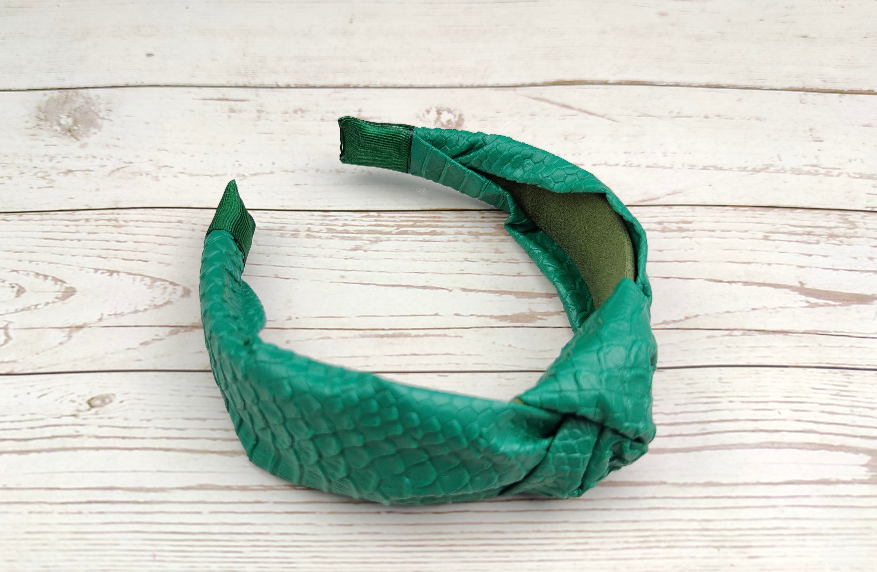 Complete any outfit with this unique green faux leather hairband.