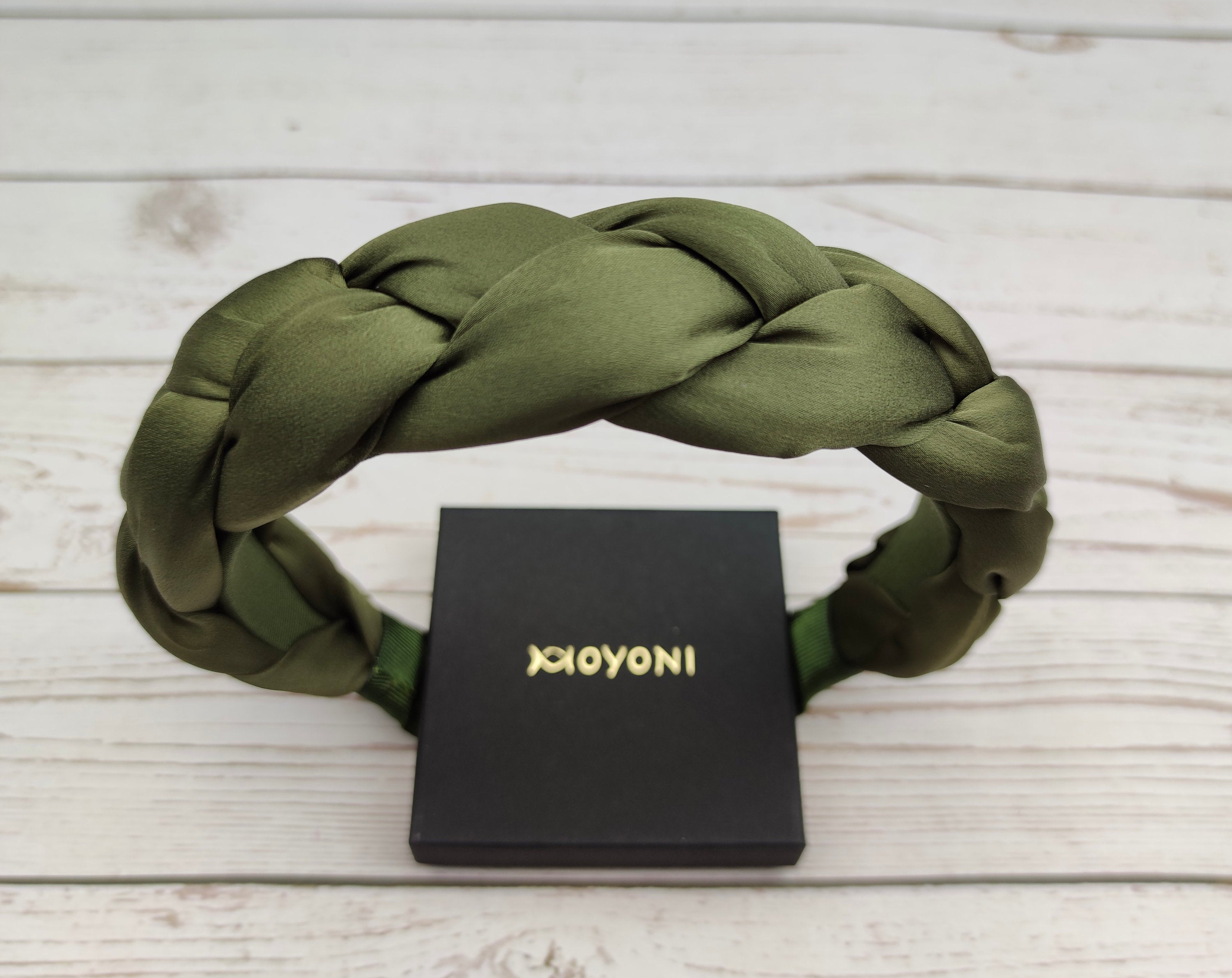 Elevate your accessory game with this trendy pea green twisted satin headband, perfect for any season.