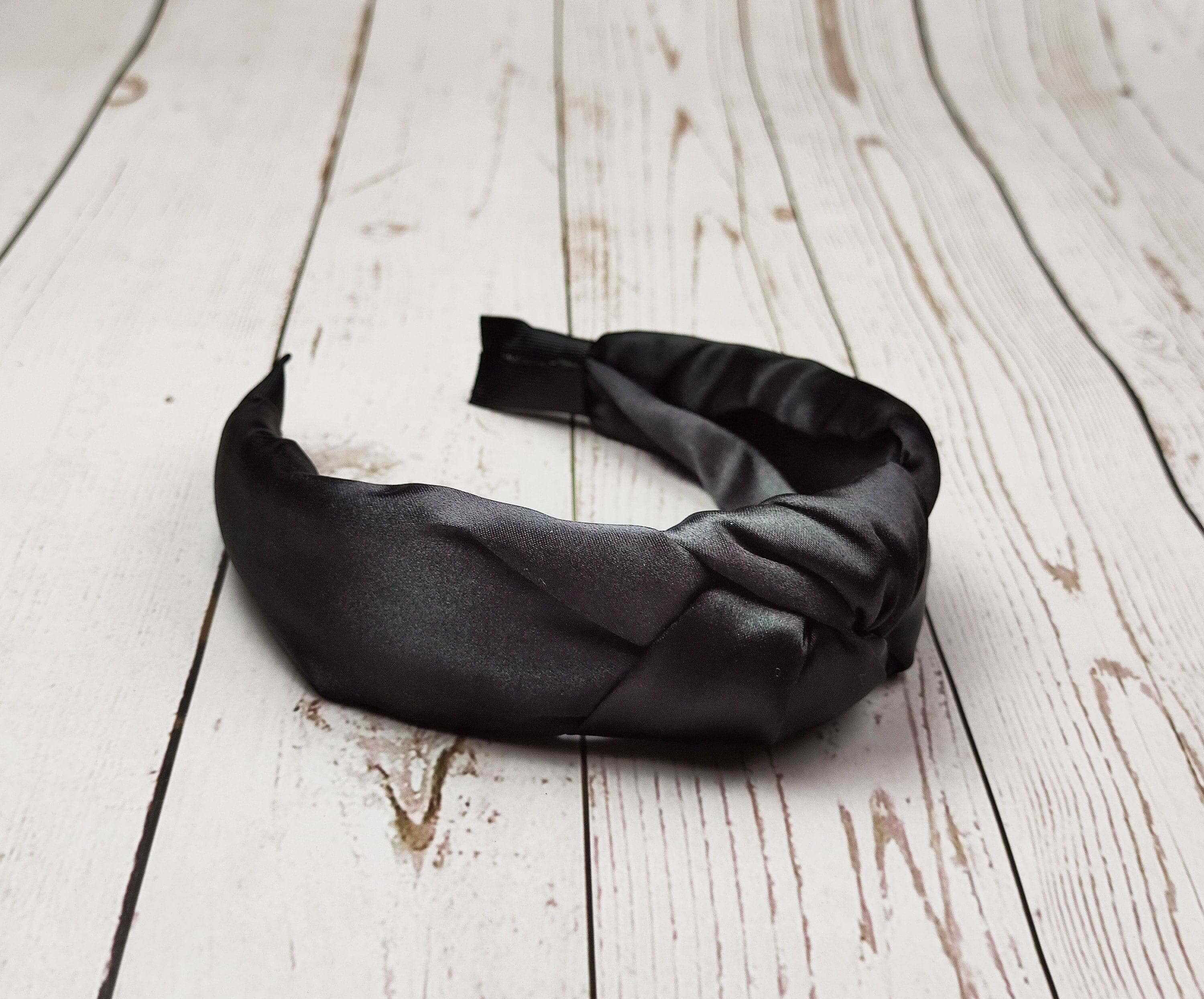 Make a statement with this dark and sophisticated black satin headband for women.