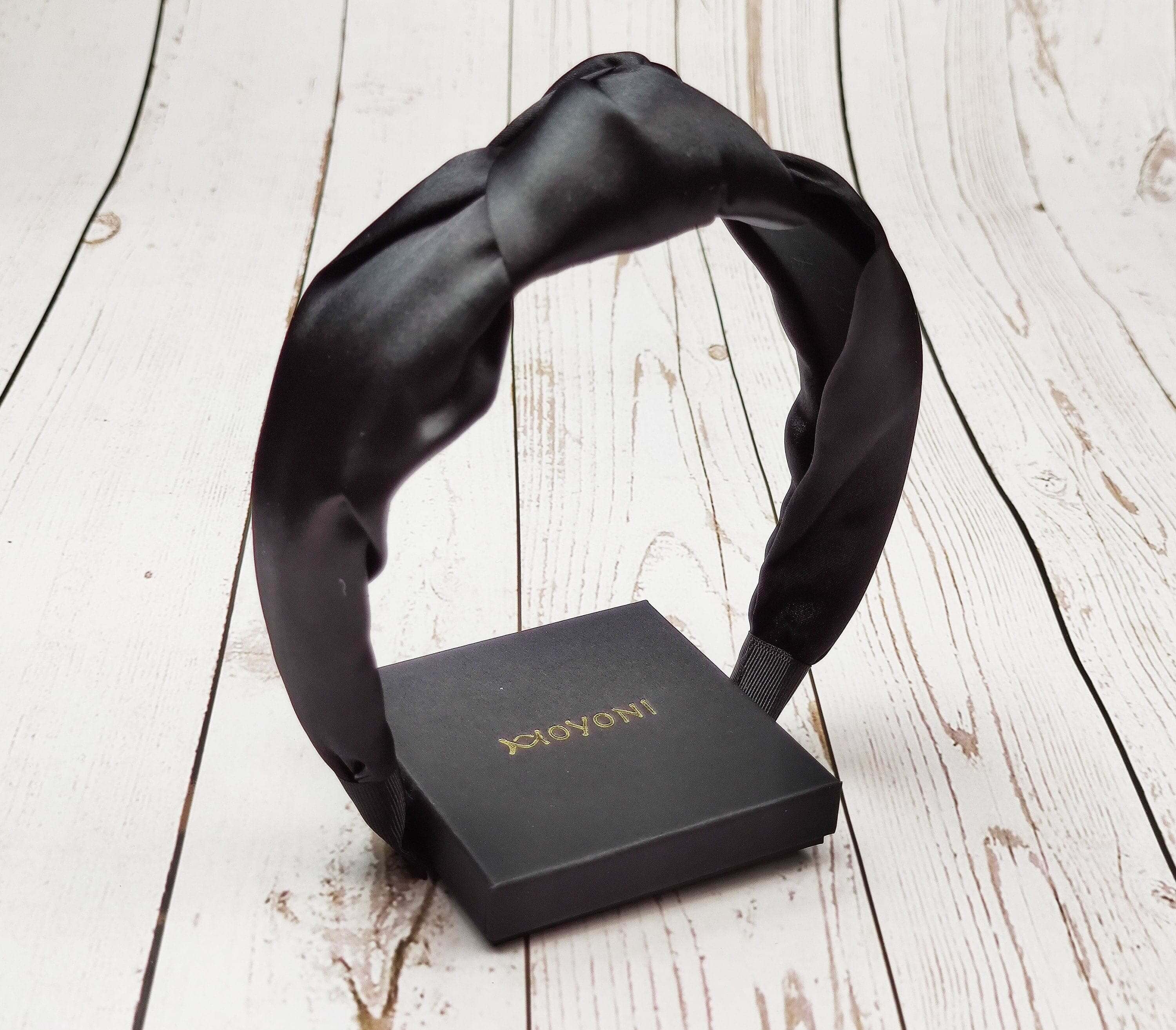 Stay on-trend with this fashionable black satin headband, the ultimate accessory for any occasion.
