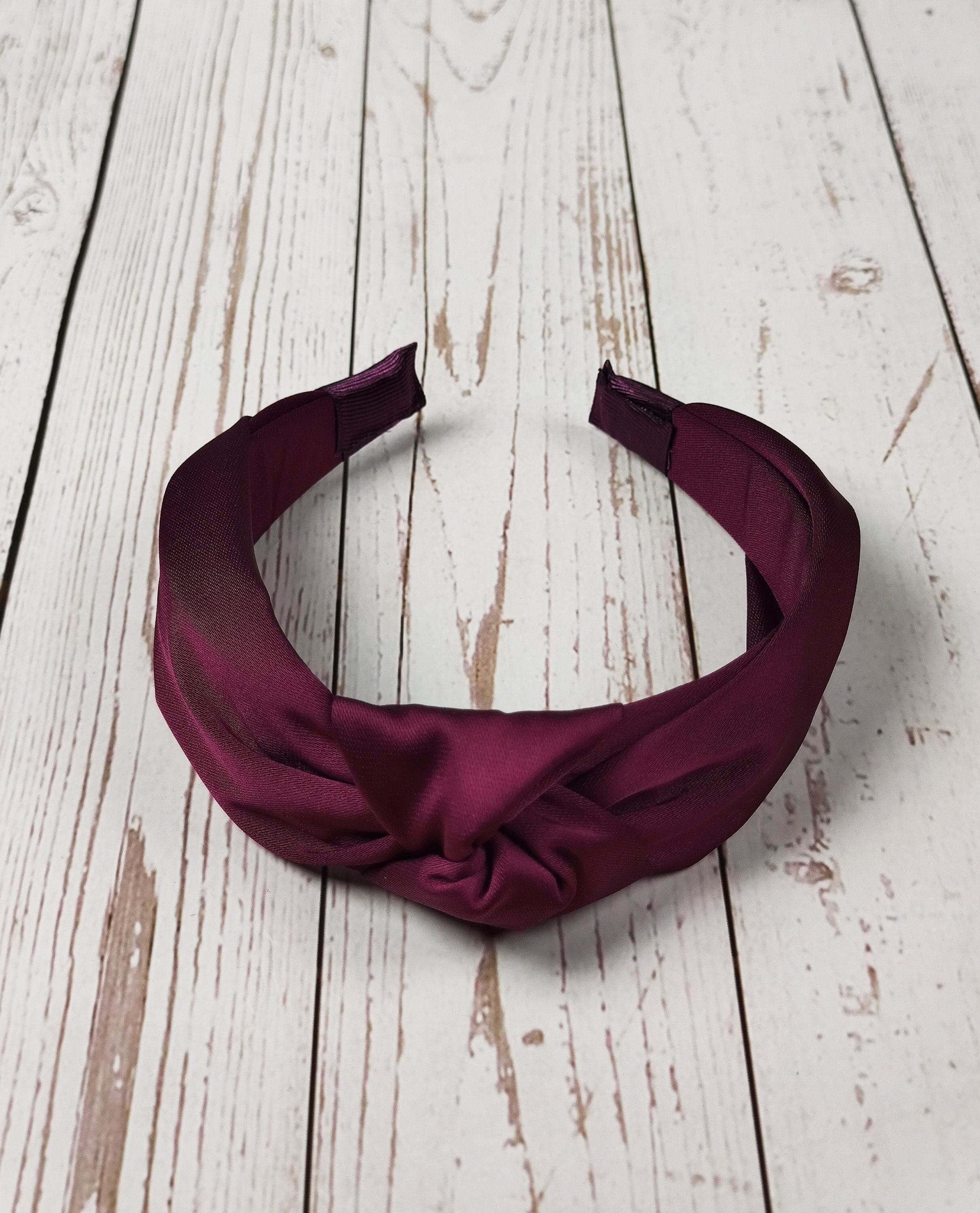 Elevate your accessory game with this chic and versatile maroon satin headband, perfect for any season.