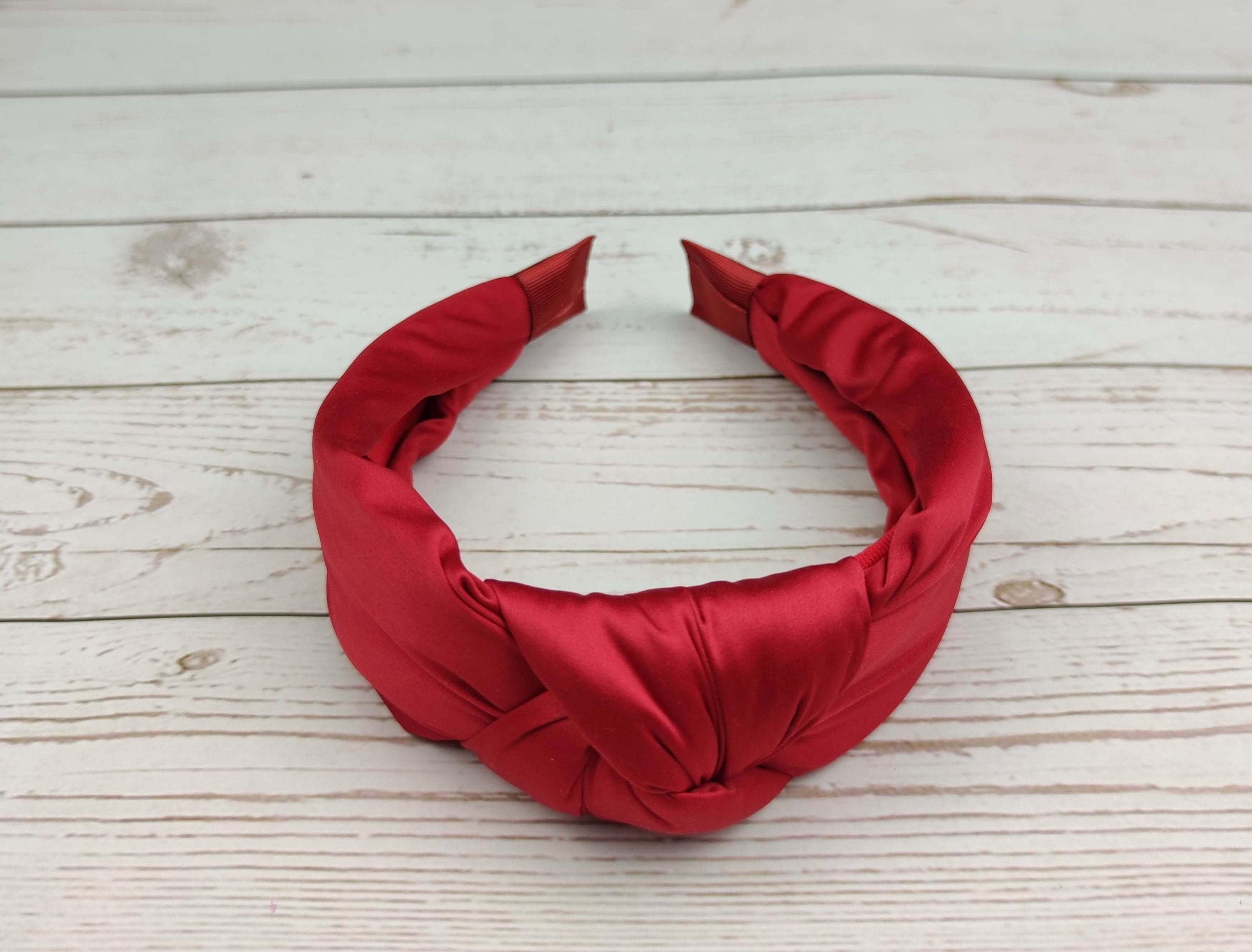 Pamper your loved one with a comfortable and stylish padded red satin headband.