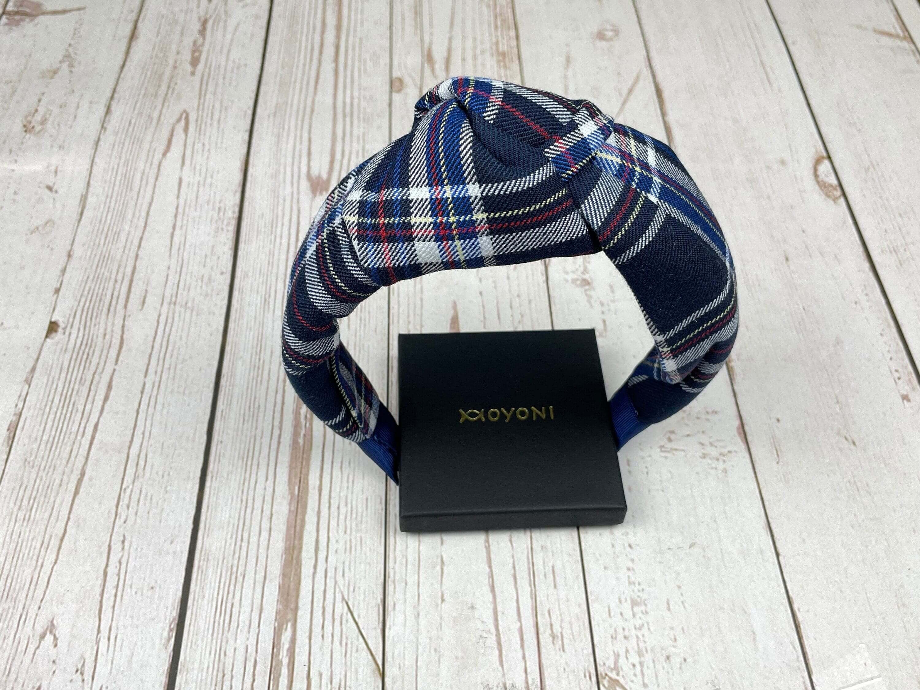 Make a statement with this headband! It comes in a cool blue plaid pattern, perfect for adding personality to any outfit.
