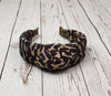 Make a bold fashion statement with this padded leopard headband, perfect for women of all ages.