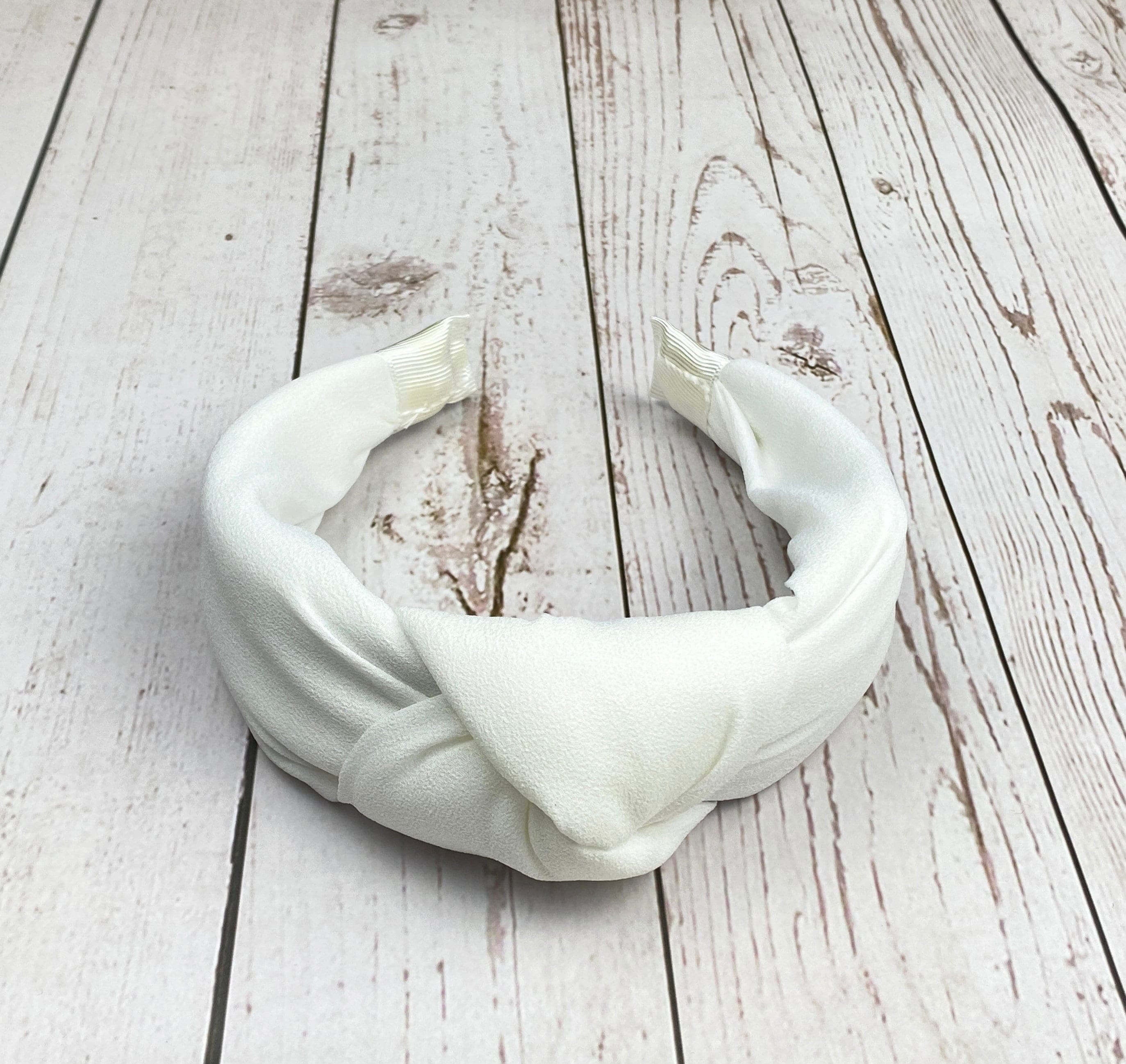 Elevate your style with this elegant white padded headband for women.
