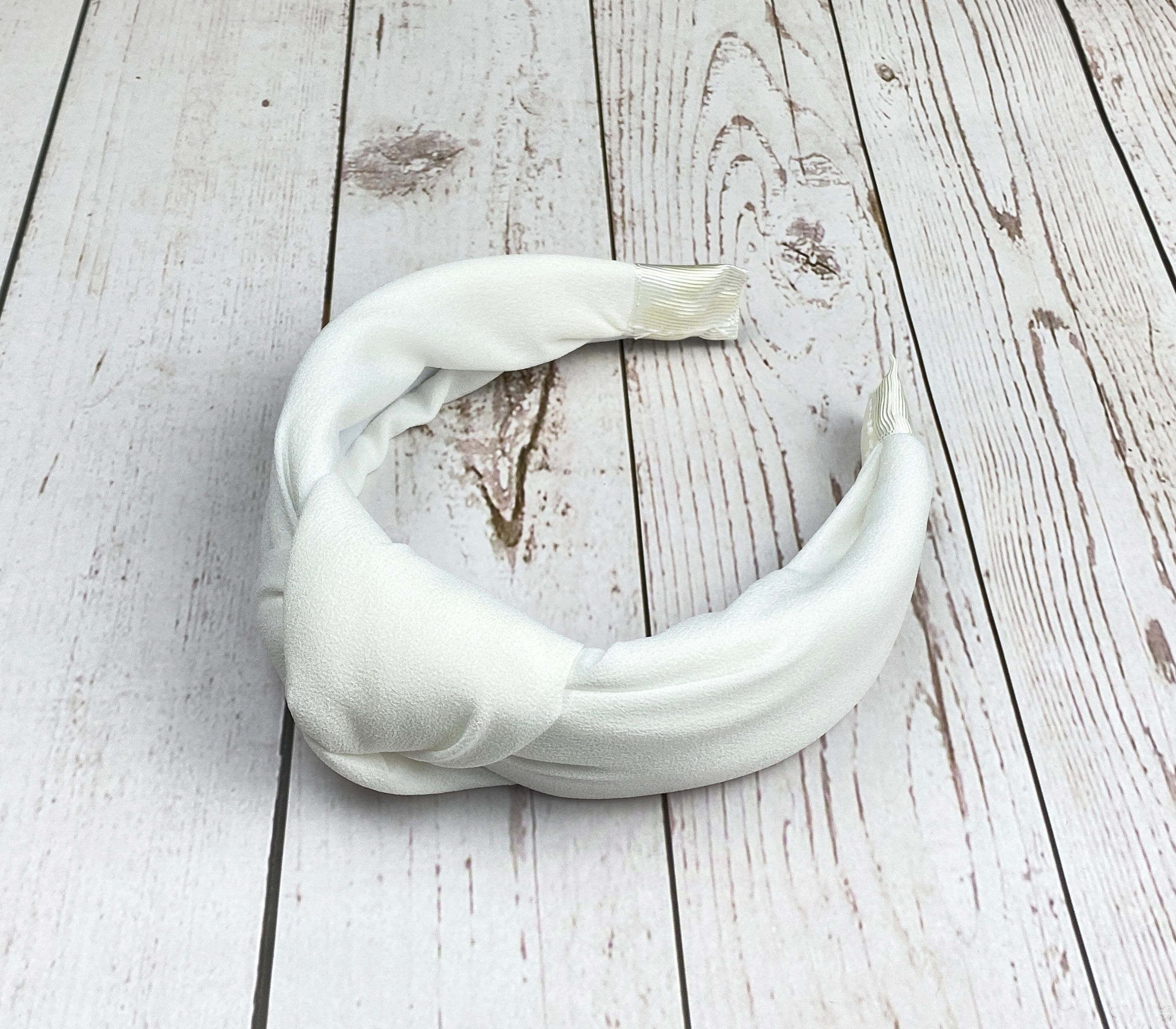 Make a statement at your next special event with this stylish white hairband.